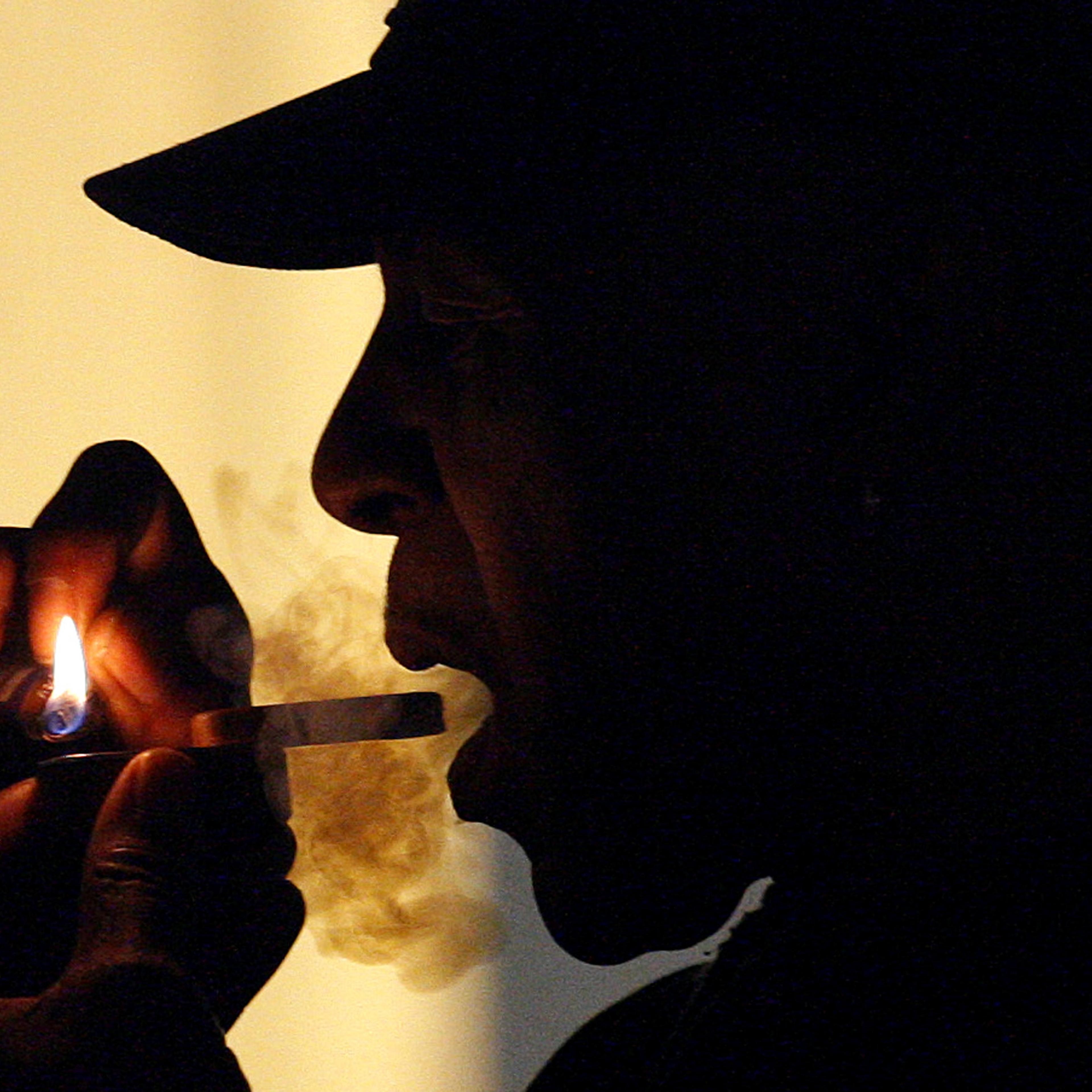 File - In this May 5, 2011, an unidentified man is seen smoking medical marijuana during karaoke night at the Cannabis Café, in Portland, Ore