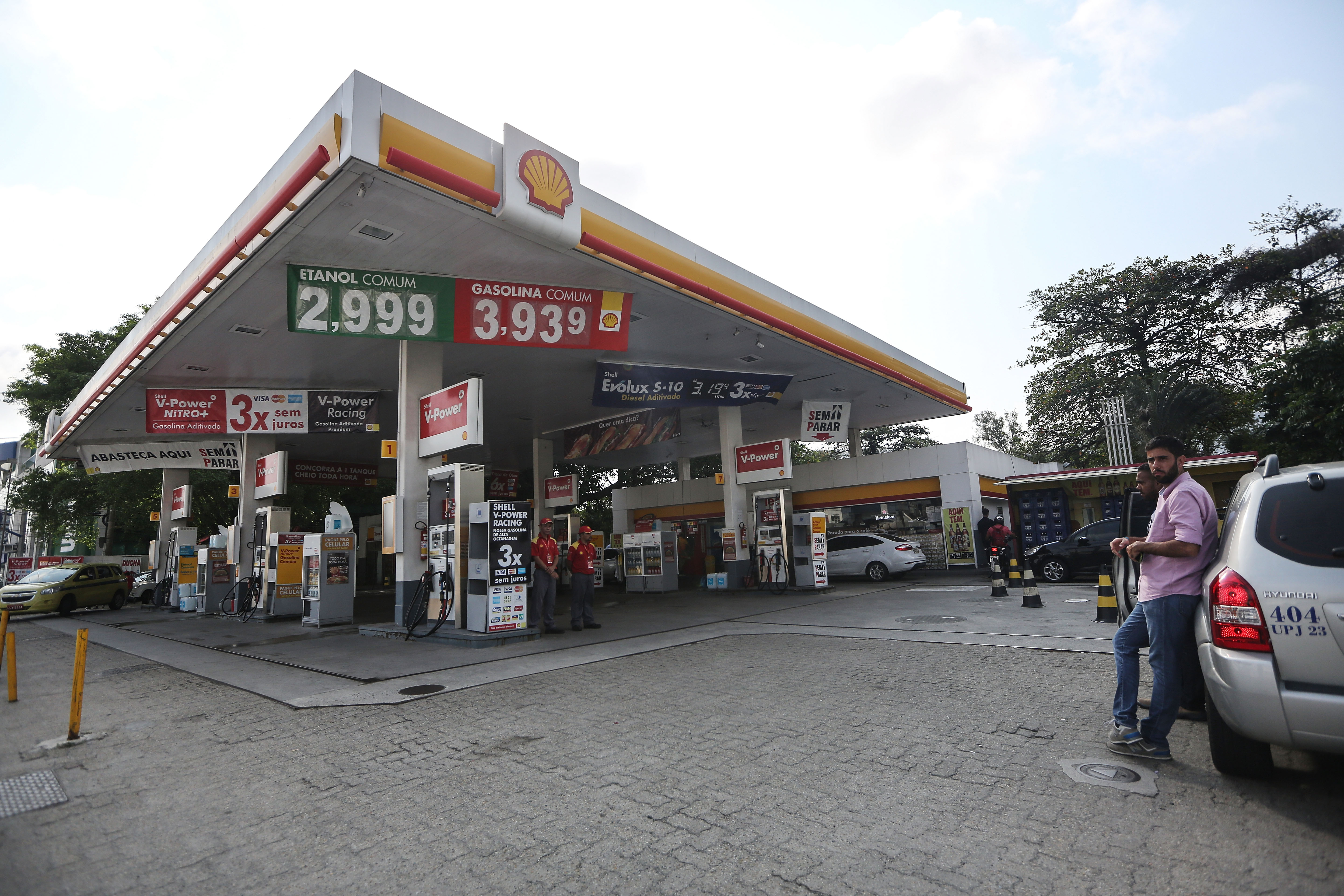 People gather at the Shell gas station where four U.S. Olympic swimmers were captured on security video in Rio de Janeiro, Brazil, on Aug. 18, 2016.
