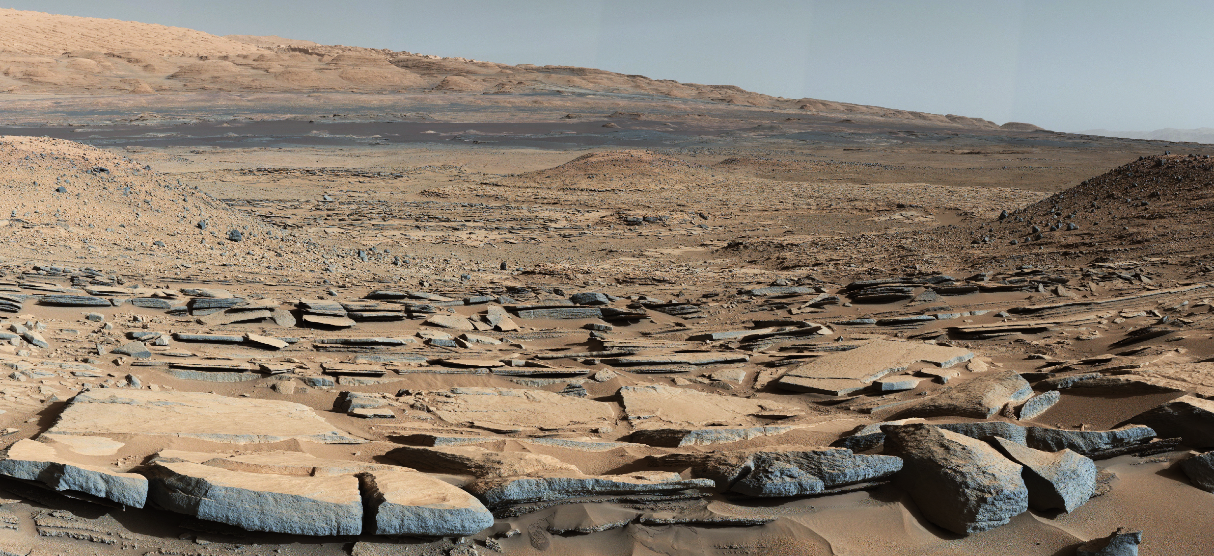This image released on Oct. 8, 2015 shows a view from the "Kimberley" formation on Mars taken by NASA's Curiosity rover. The strata in the foreground dip towards the base of Mount Sharp, indicating flow of water toward a basin that existed before the larger bulk of the mountain formed.