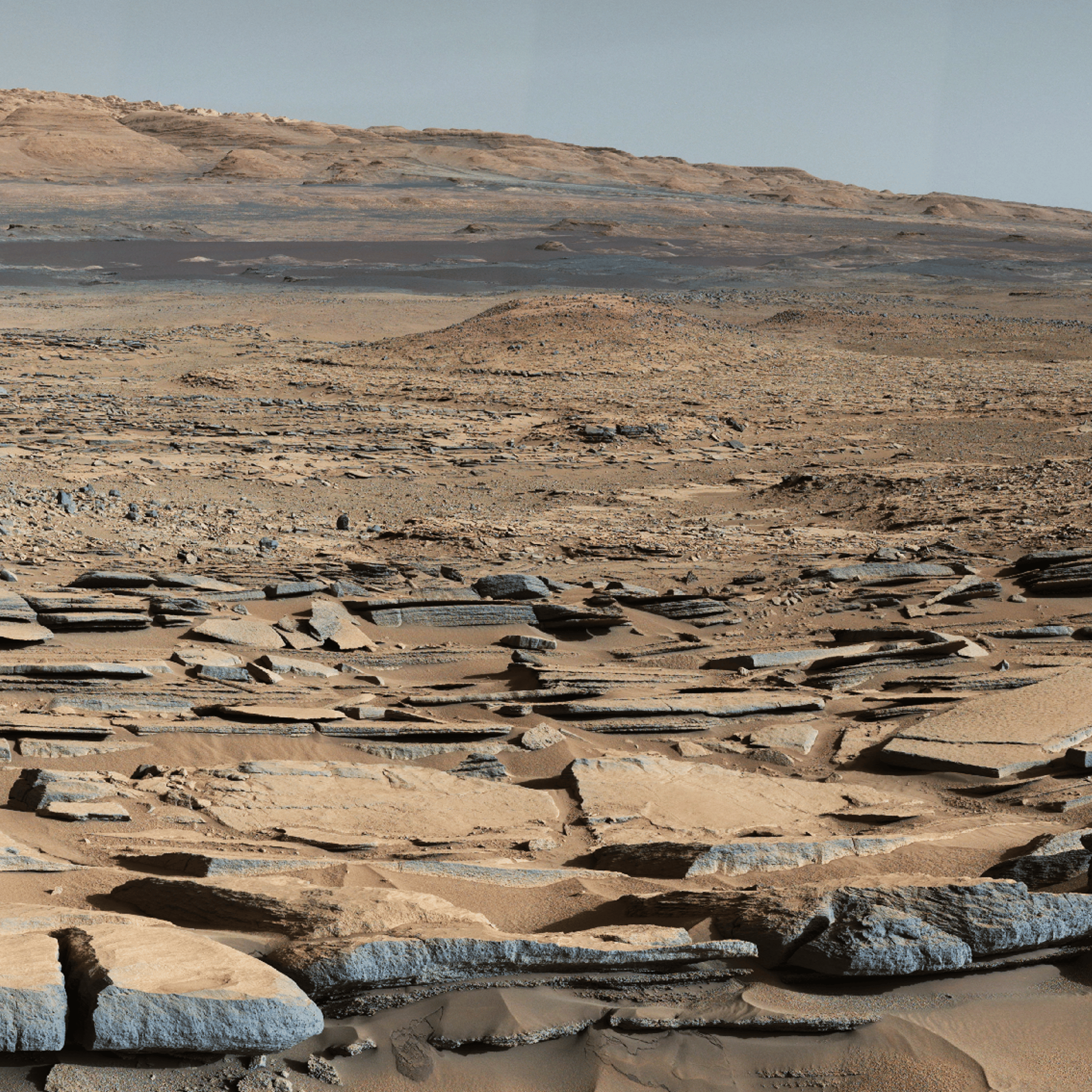 This image released on Oct. 8, 2015 shows a view from the "Kimberley" formation on Mars taken by NASA's Curiosity rover. The strata in the foreground dip towards the base of Mount Sharp, indicating flow of water toward a basin that existed before the larger bulk of the mountain formed.