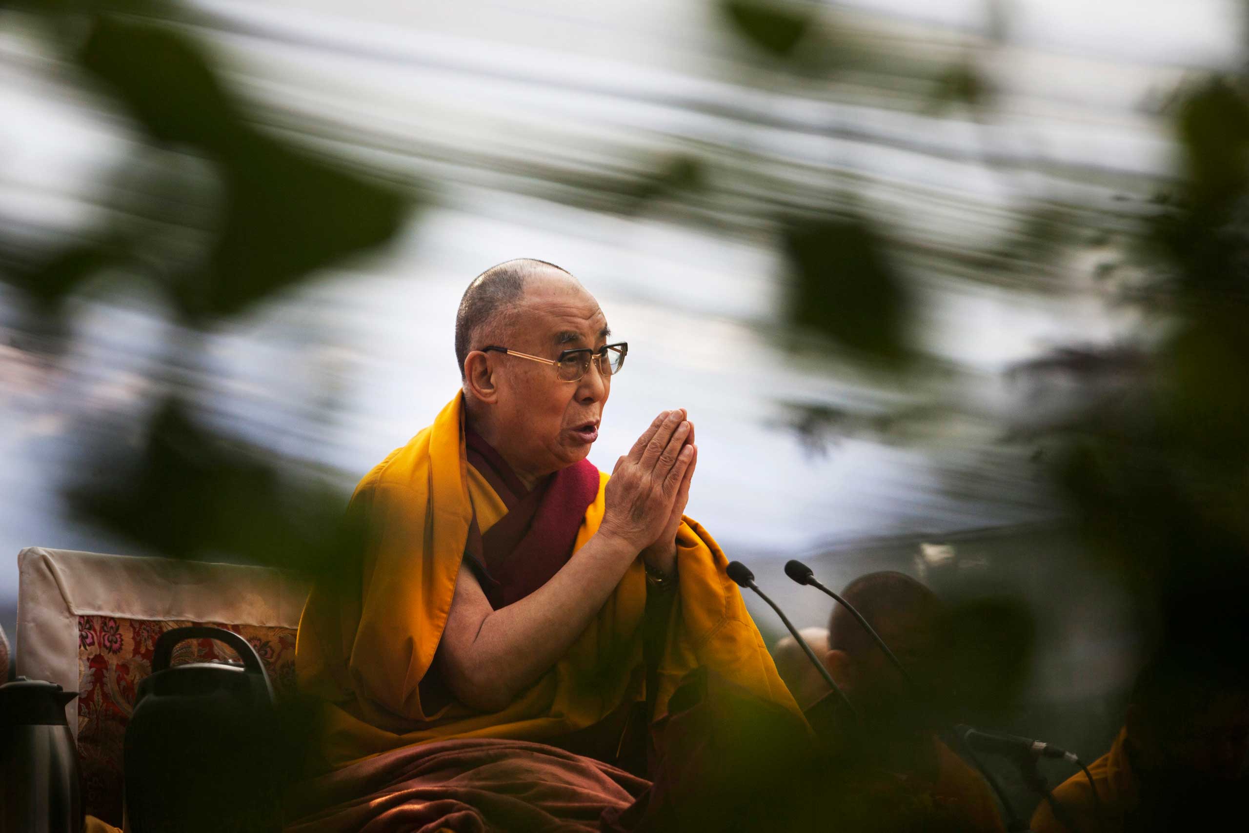 Tibetan spiritual leader the Dalai Lama prays during Ganden Ngachoe, the death anniversary of 14th Century Tibetan Saint-Scholar Lama Tsongkhapa, in New Delhi, India, Dec. 16, 2014.