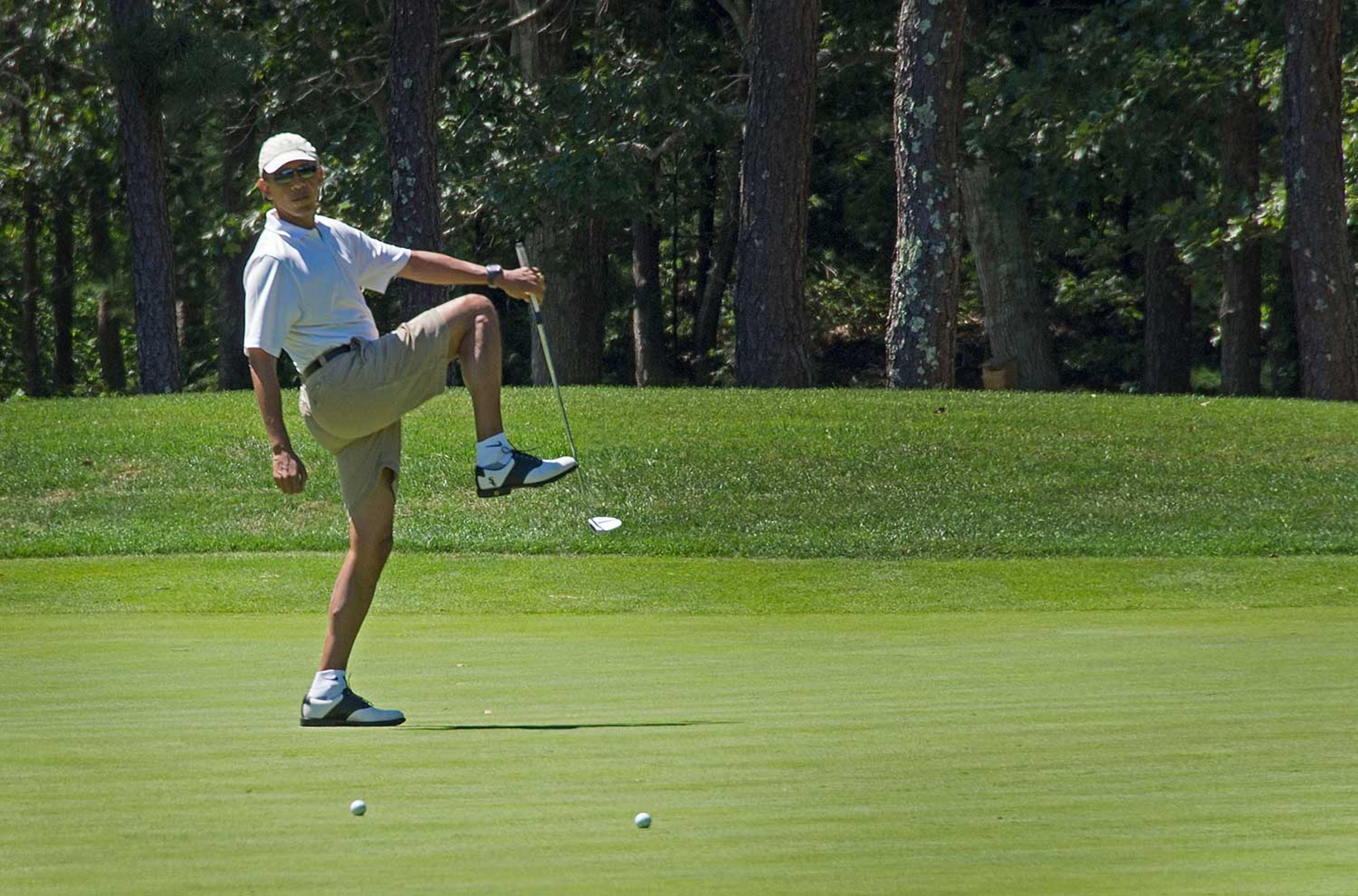 US President Barack Obama reacts to a missed putt on the first green at Farm Neck Golf Club in Oak Bluffs, Mass. on August 11, 2013 during the Obama family vacation to Martha's Vineyard.
