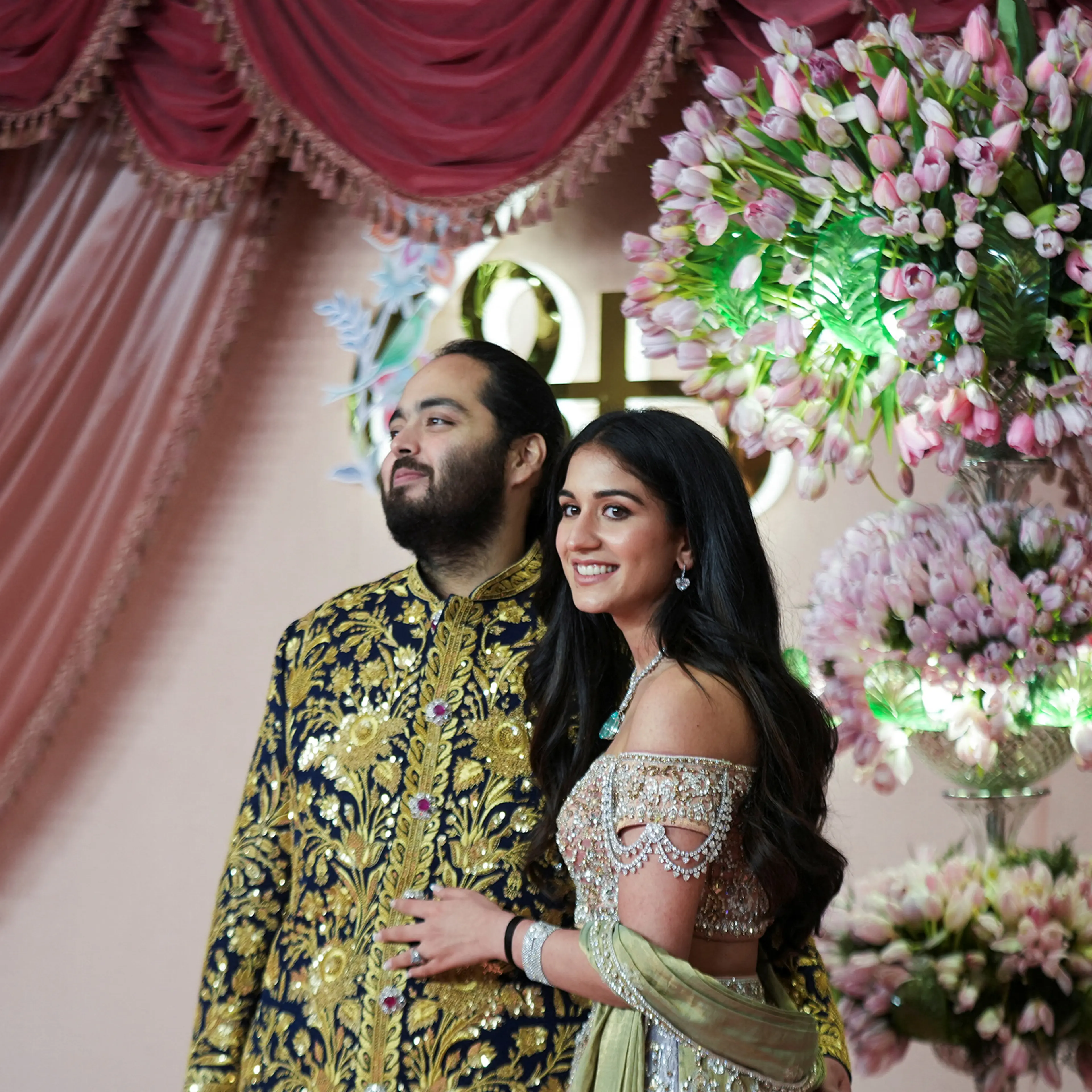 Anant Ambani, son of businessman Mukesh Ambani, poses with his fiance Radhika Merchant on the red carpet during the sangeet ceremony at Jio World Centre, Mumbai, India, on July 5, 2024.