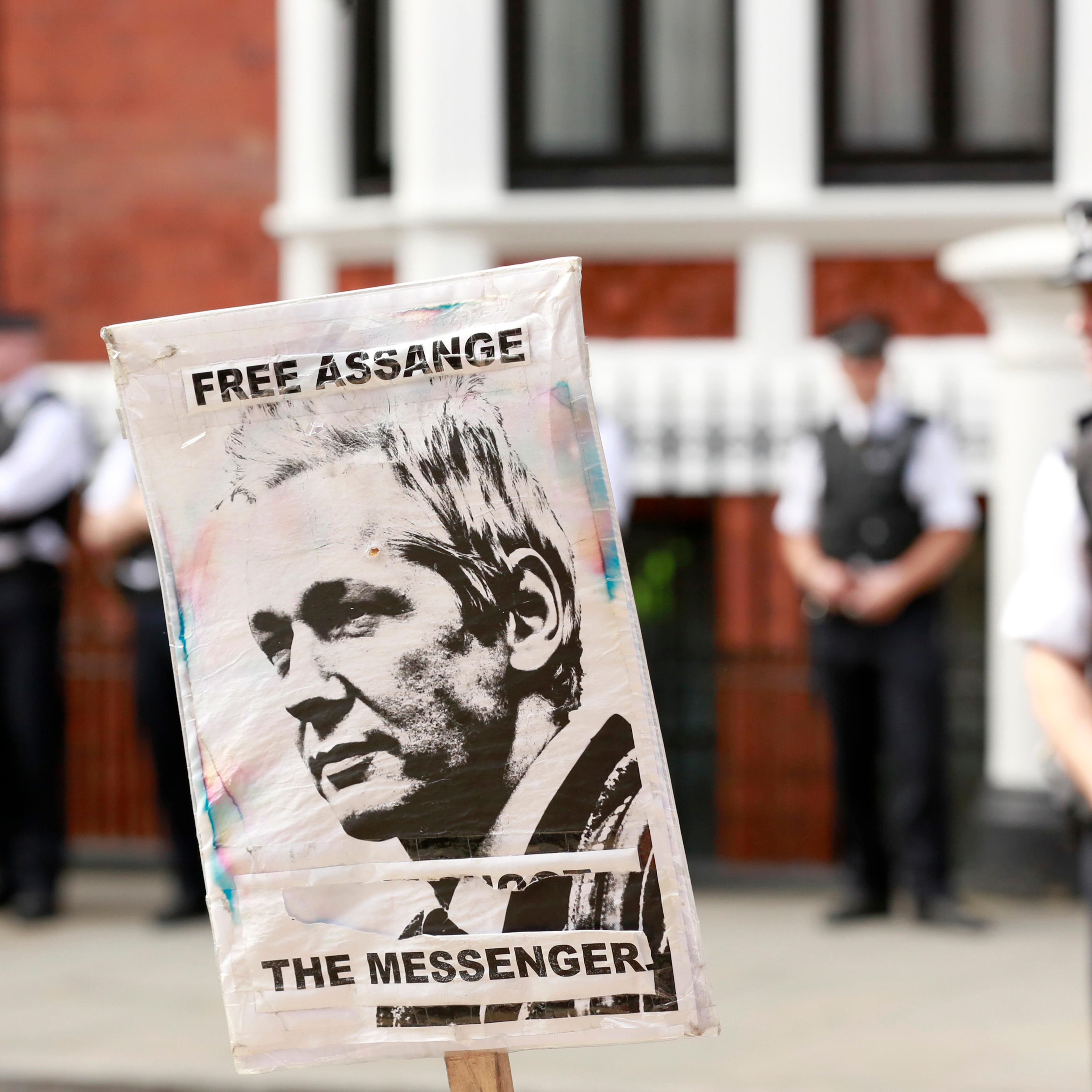 Police and protesters wait for Wikileaks founder Julian Assange to speak to the media outside the Ecuador embassy in west London