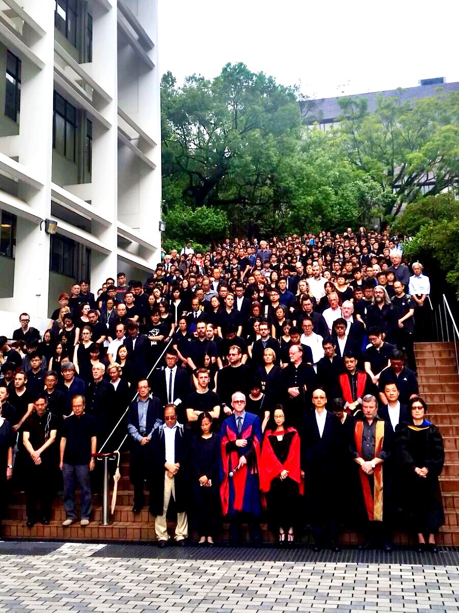 Faculty and students of the University of Hong Kong gather on the steps of the university's Sun Yat-sen Place after their silent protest march on Oct. 6, 2015