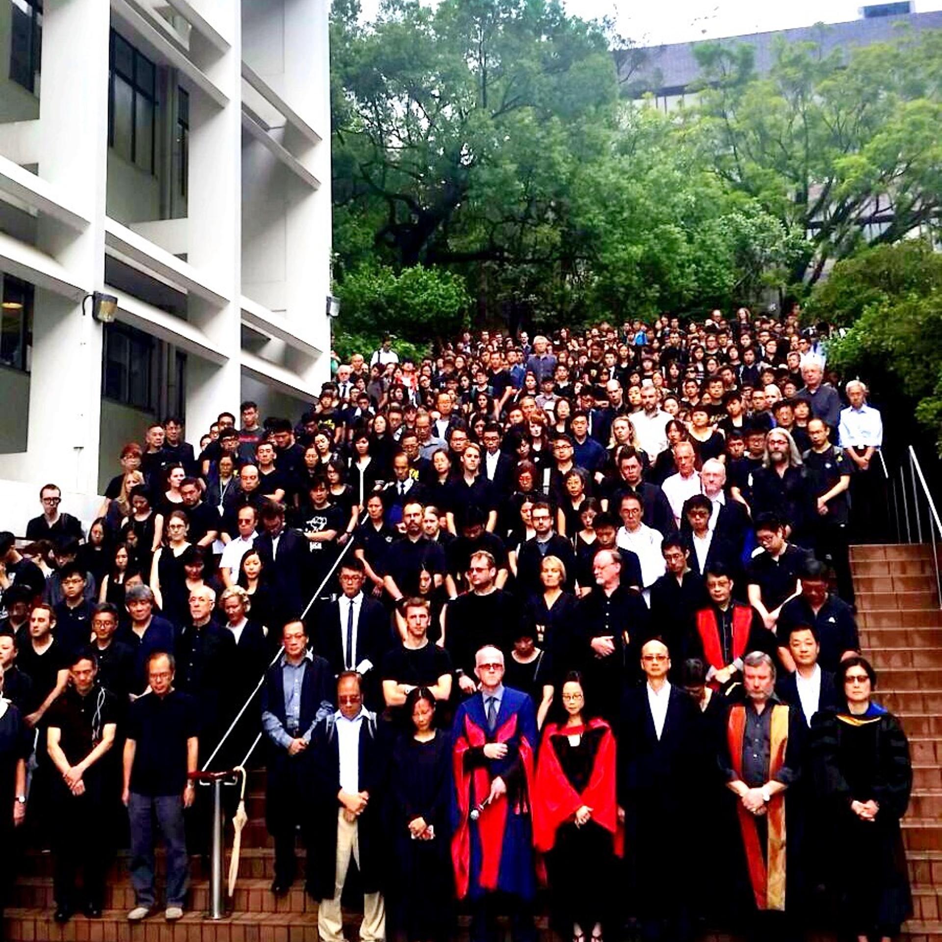Faculty and students of the University of Hong Kong gather on the steps of the university's Sun Yat-sen Place after their silent protest march on Oct. 6, 2015