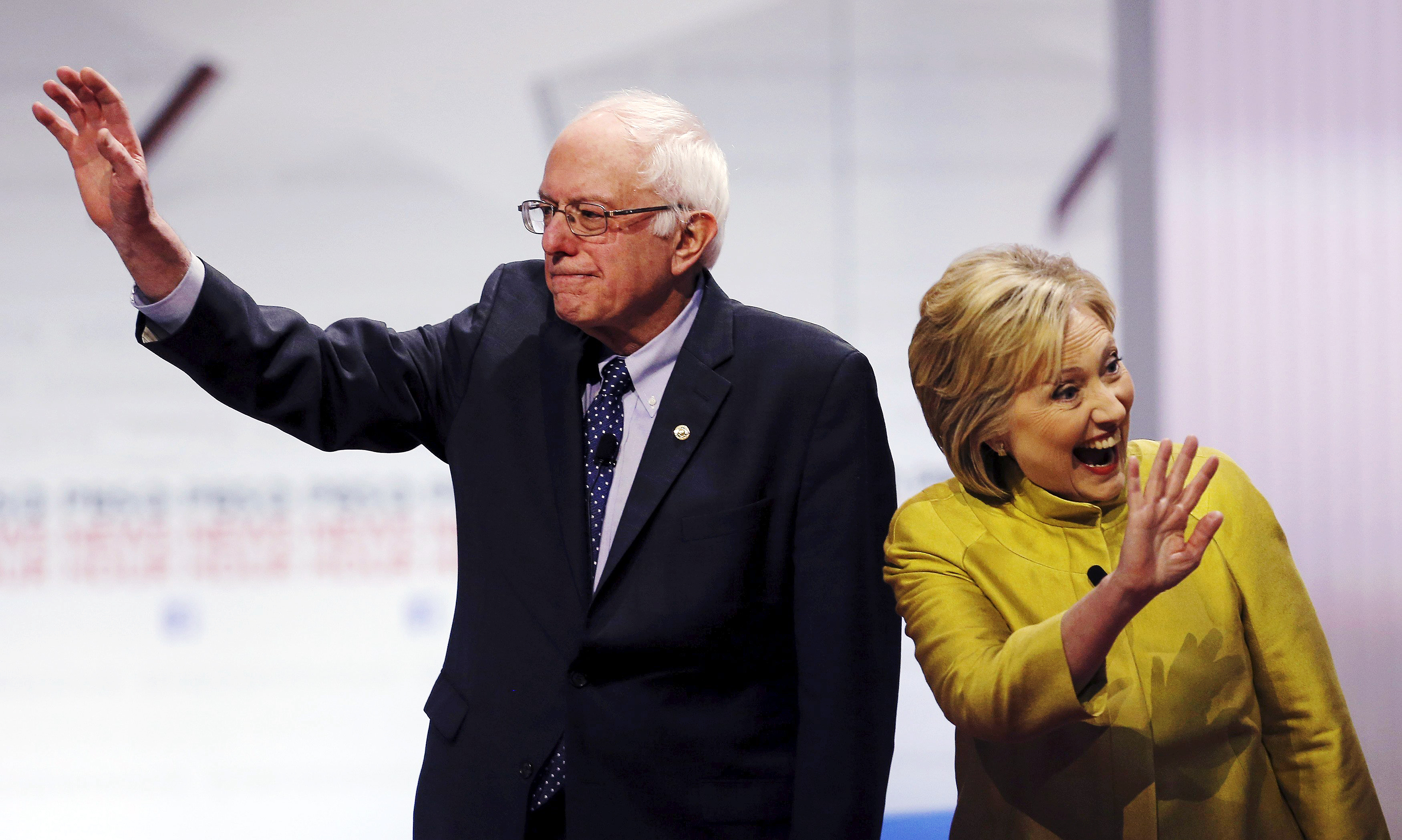 Democratic U.S. presidential candidates Senator Bernie Sanders and former Secretary of State Hillary Clinton arrive on stage before the start of the PBS NewsHour Democratic presidential candidates debate in Milwaukee