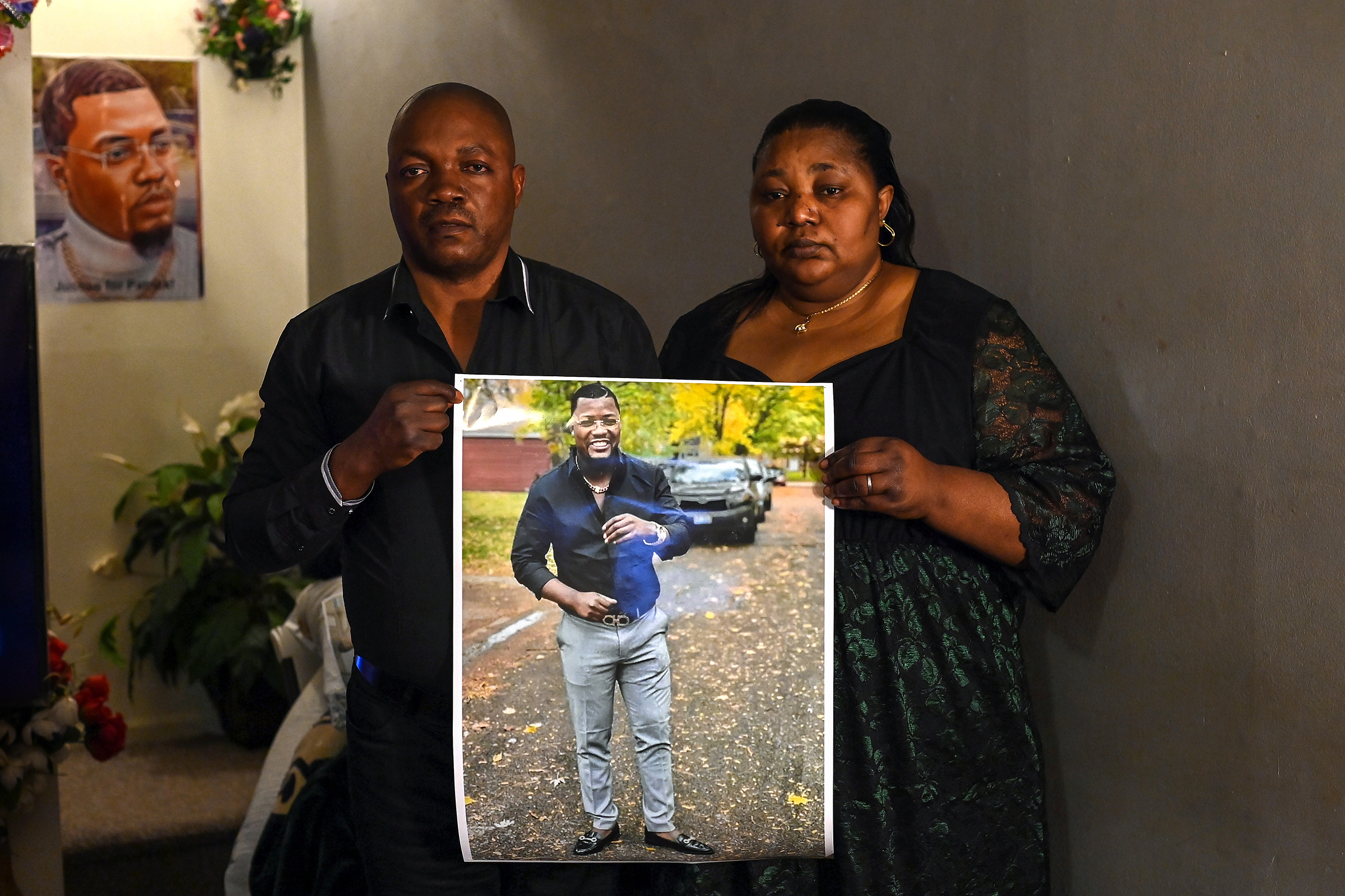 Patrick Lyoya's parents Peter Lyoya and Dorcas Lyoya pose for a portrait as they hold a photo of their son at their home on April 15, 2022 in Lansing, Mich. 