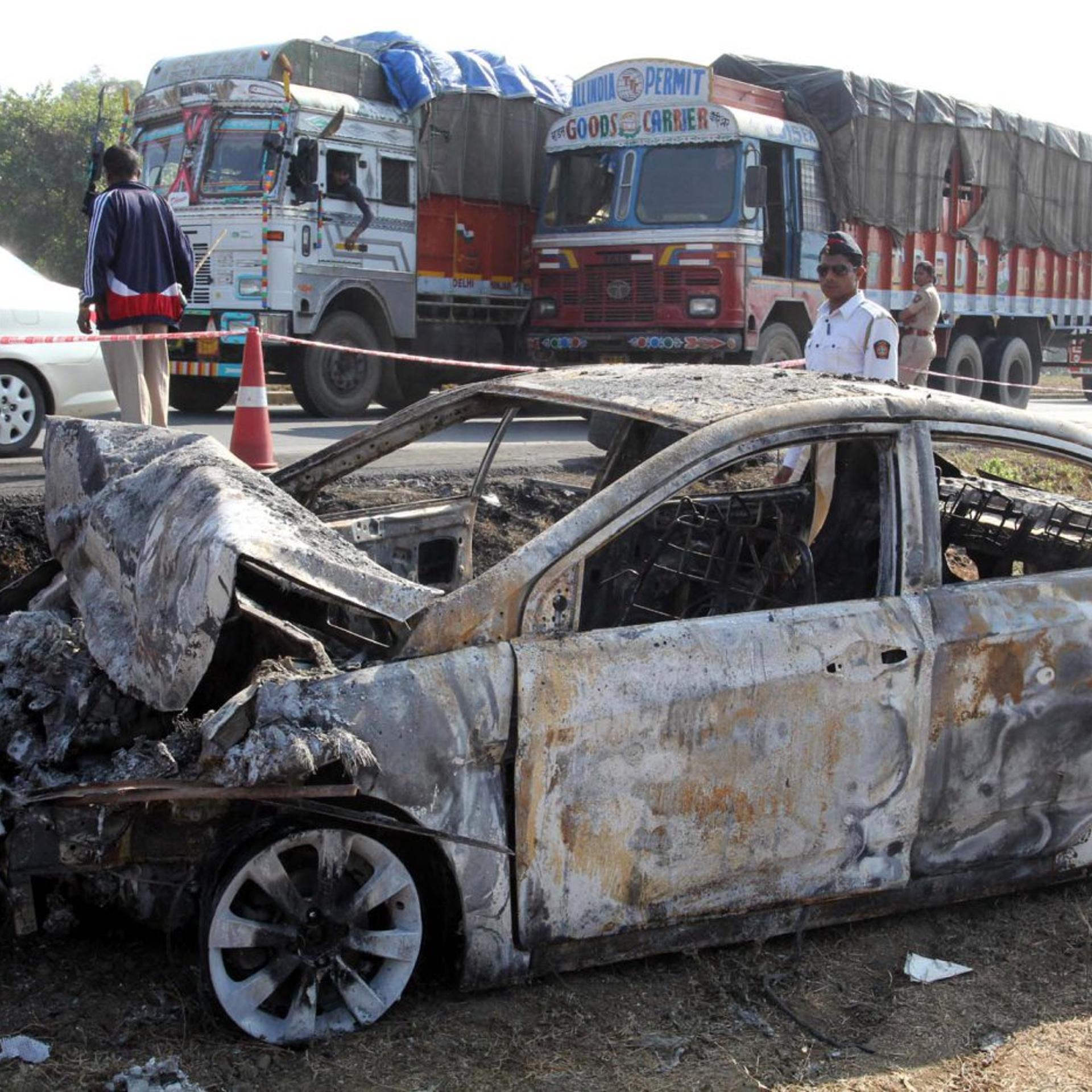 A charred car stands at the accident spot on the Mumbai-Ahmedabad highway near Manor police station following the collision between a tanker containing diesel and a luxury bus on Jan. 29, 2014, in Mumbai, India.