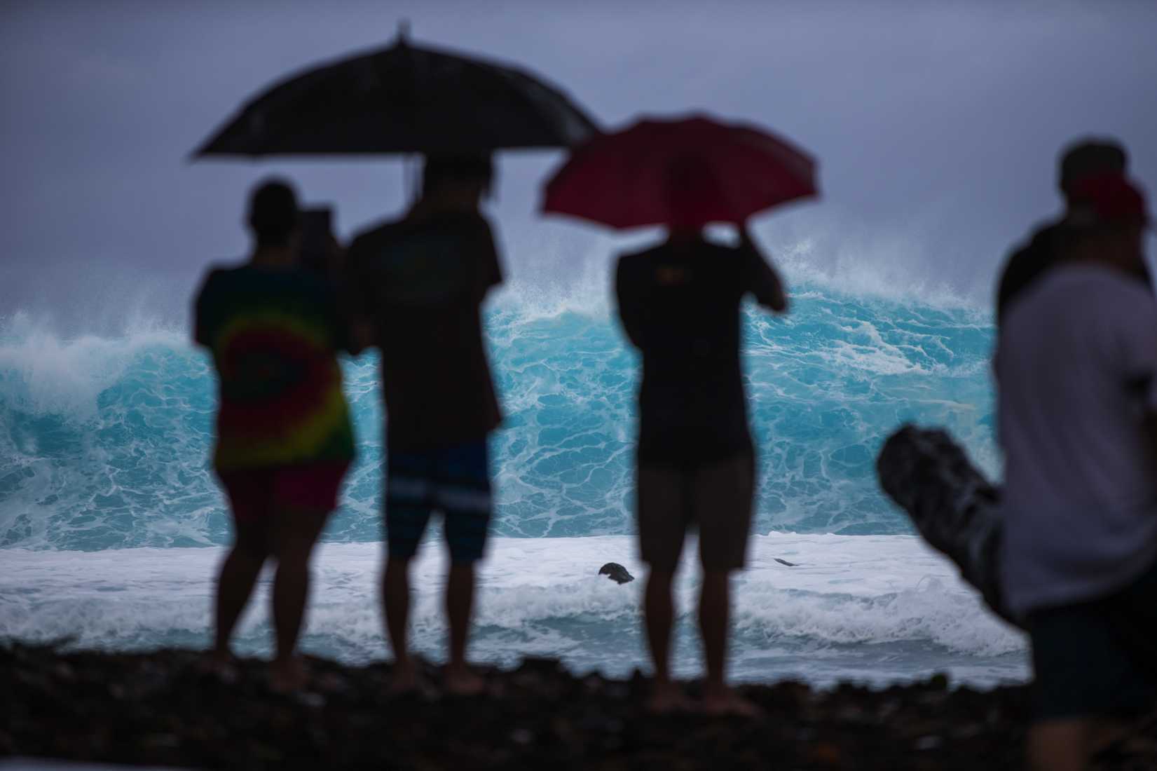 Spectators line the coast to watch large swells generated by the approaching Hurricane Iselle in Pohoiki, on the Big Island of Hawaii, August 7, 2014.