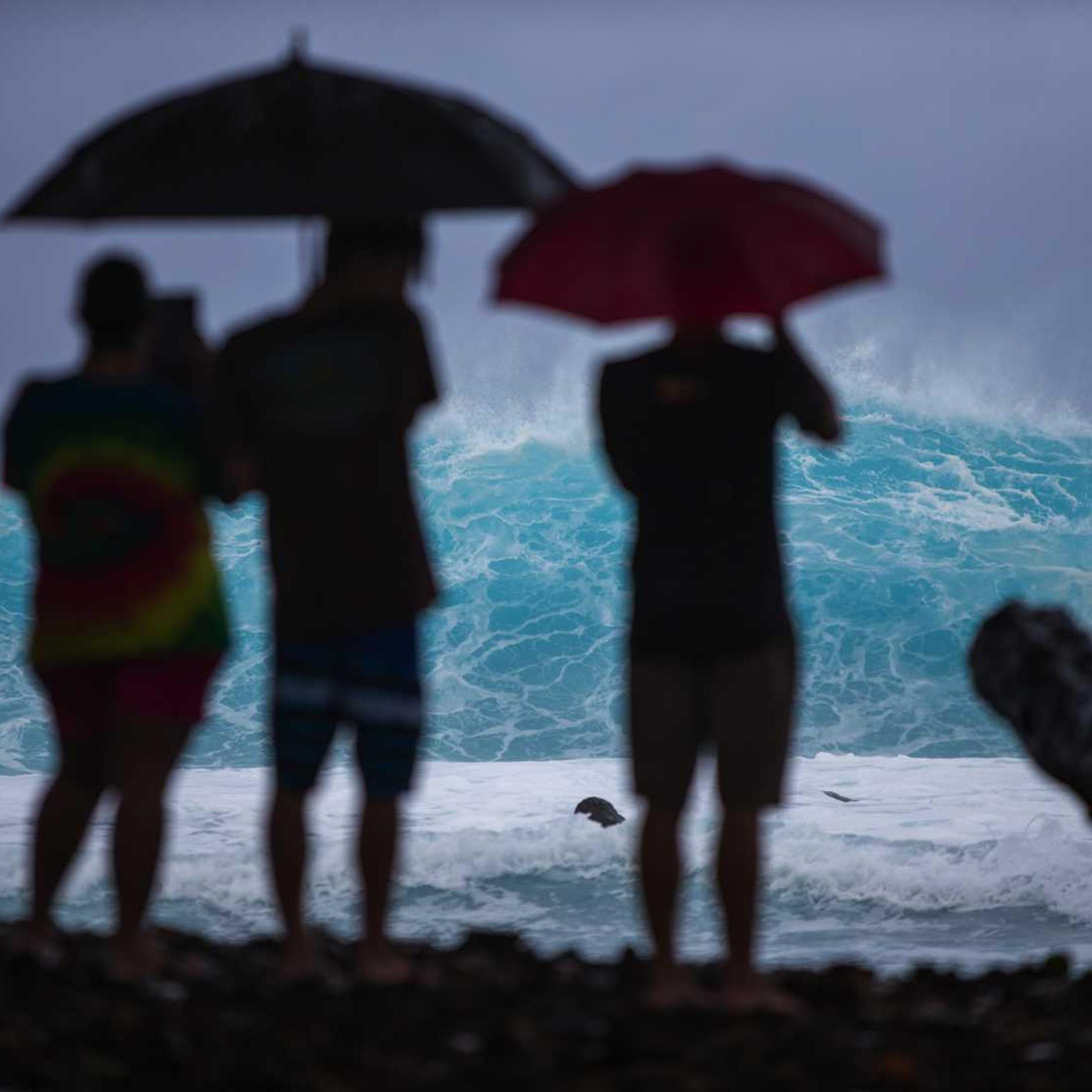 Spectators line the coast to watch large swells generated by the approaching Hurricane Iselle in Pohoiki, on the Big Island of Hawaii, August 7, 2014.