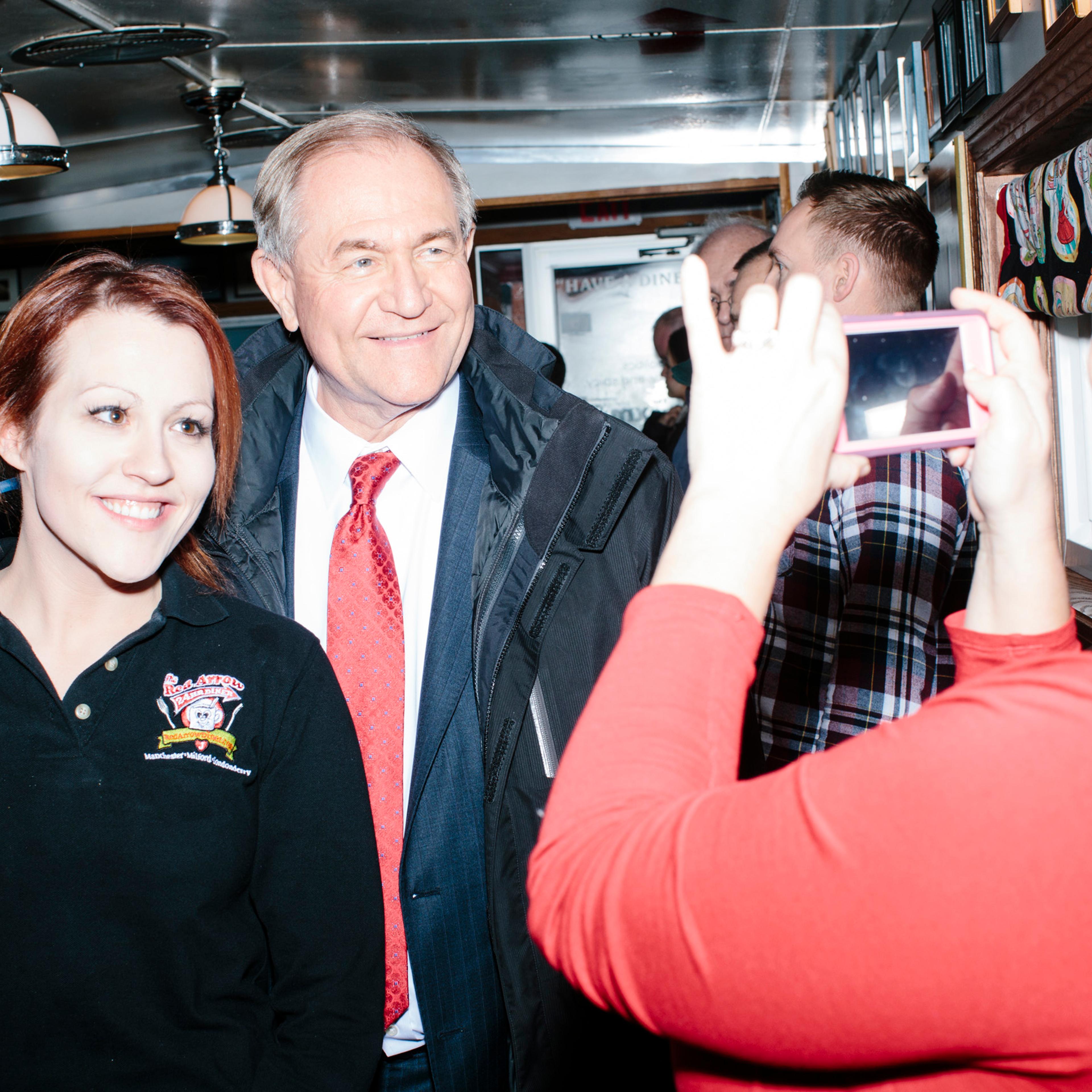Former Virginia governor and Republican presidential candidate Jim Gilmore poses for a picture with general manager Jayme Lemay, of Nashua, NH, at the Red Arrow Diner in Manchester, New Hampshire, on Mon., Feb. 8, 2016. The Red Arrow Diner is a frequent