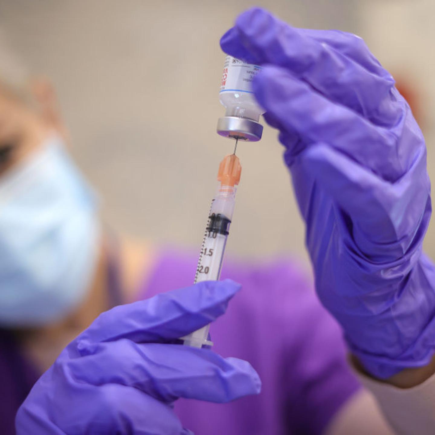Nurses draw vaccine doses from a vial as Maryland residents receive their second dose of the Moderna coronavirus vaccine at the Cameron Grove Community Center on March 25, 2021 in Bowie, Maryland.