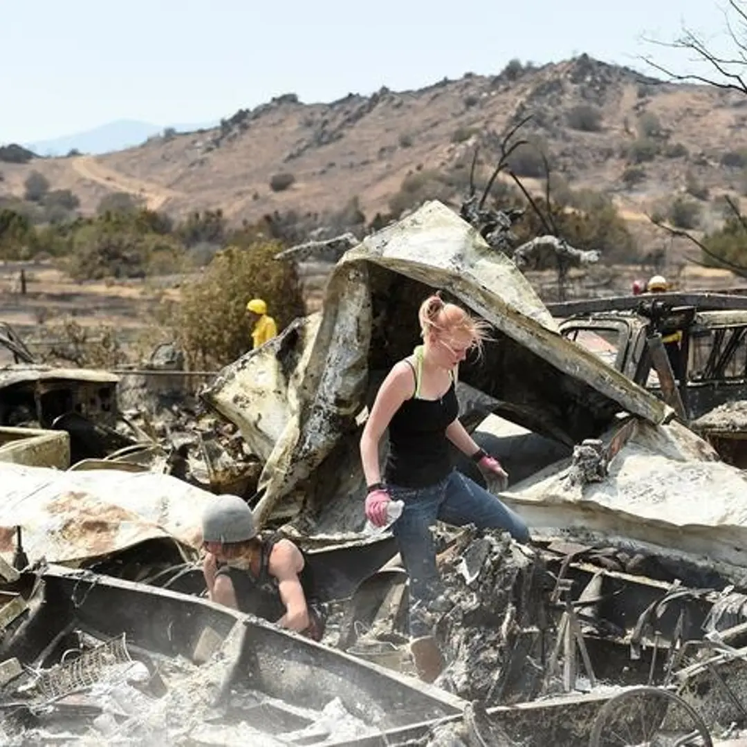 Emily Fryer, 20, searches for family heirlooms at her boyfriend's leveled home after the Erskine Fire burned through South Lake
