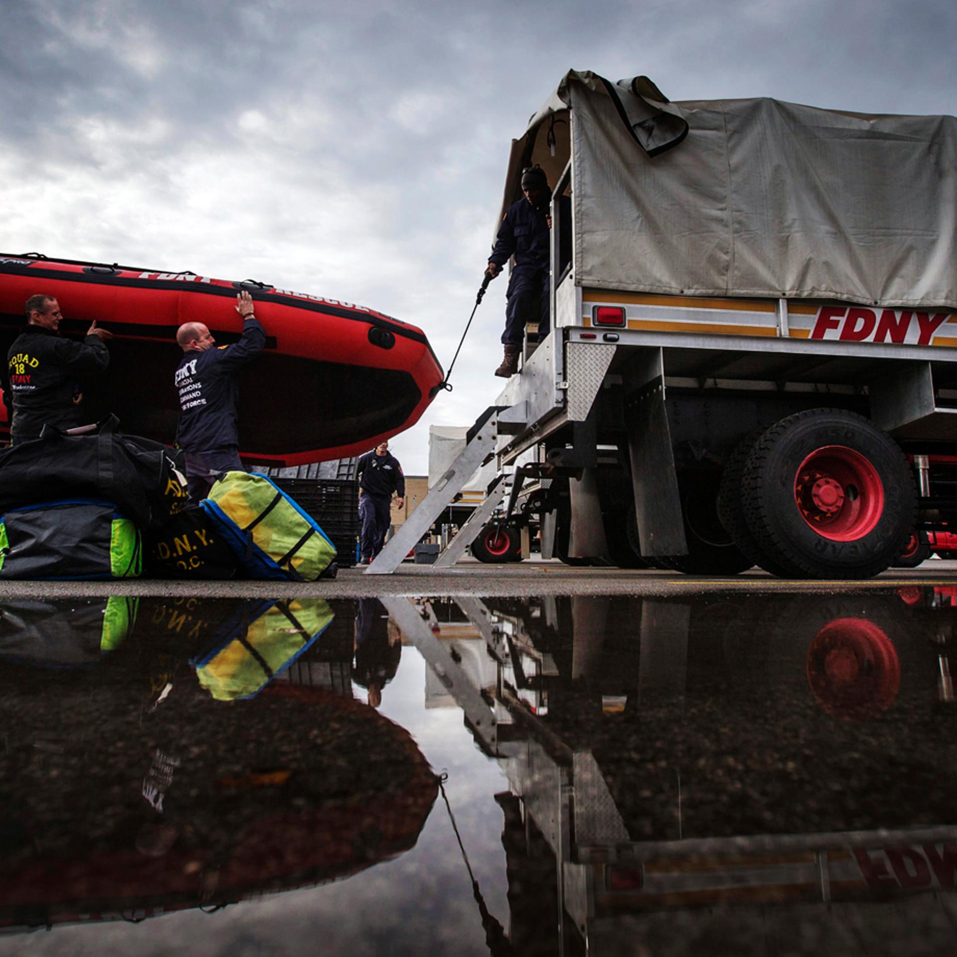 FDNY firefighters from New York City load a rescue boat to prepare for possible flooding following a massive snow storm in Williamsville