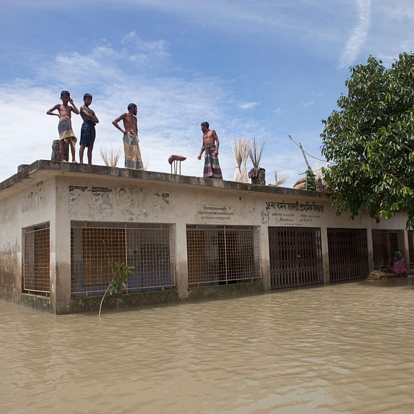 People take shelter on a school roof in Bangladesh