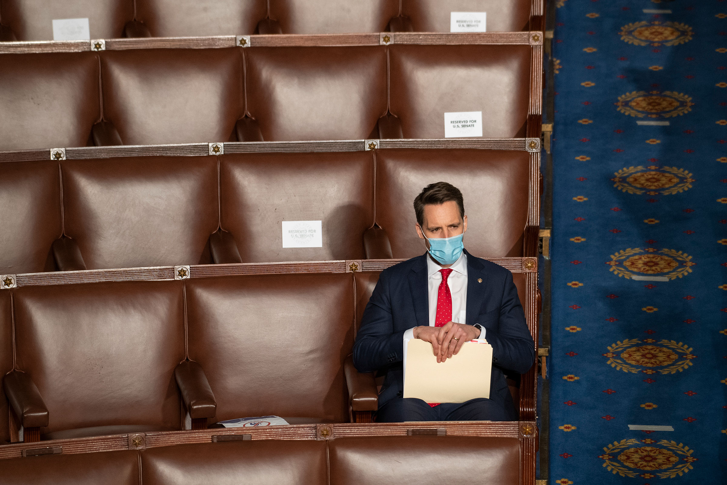 Sen. Josh Hawley attends a joint session of Congress to certify the Electoral College votes of the 2020 presidential election in the House chamber on Jan. 6, 2021.