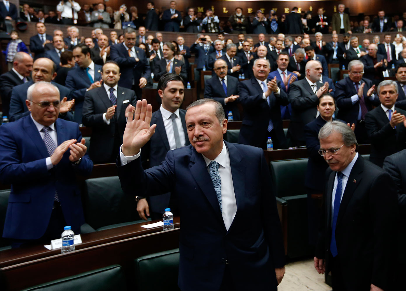 Turkey's Prime Minister Tayyip Erdogan greets his supporters as he arrives at a meeting at the Turkish parliament in Ankara