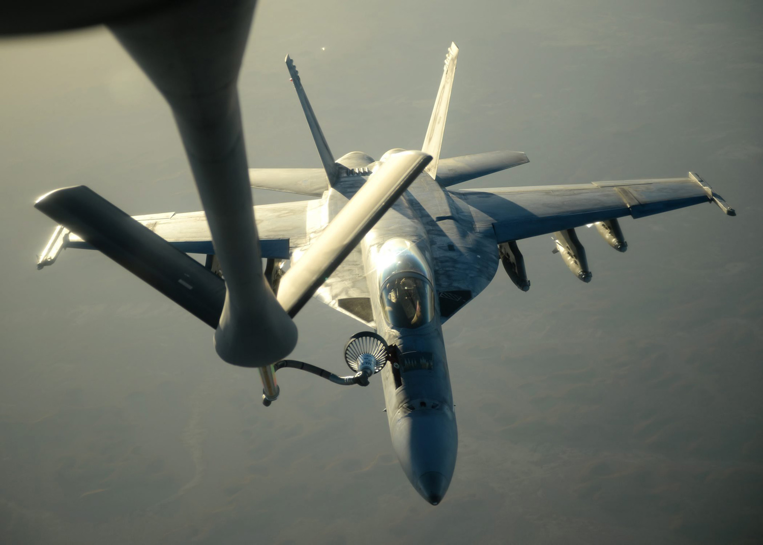 A US Navy F-18E Super Hornet receiving fuel from a KC-135 Stratotanker over northern Iraq after conducting air strikes in Syria, Sept. 23 2014.
