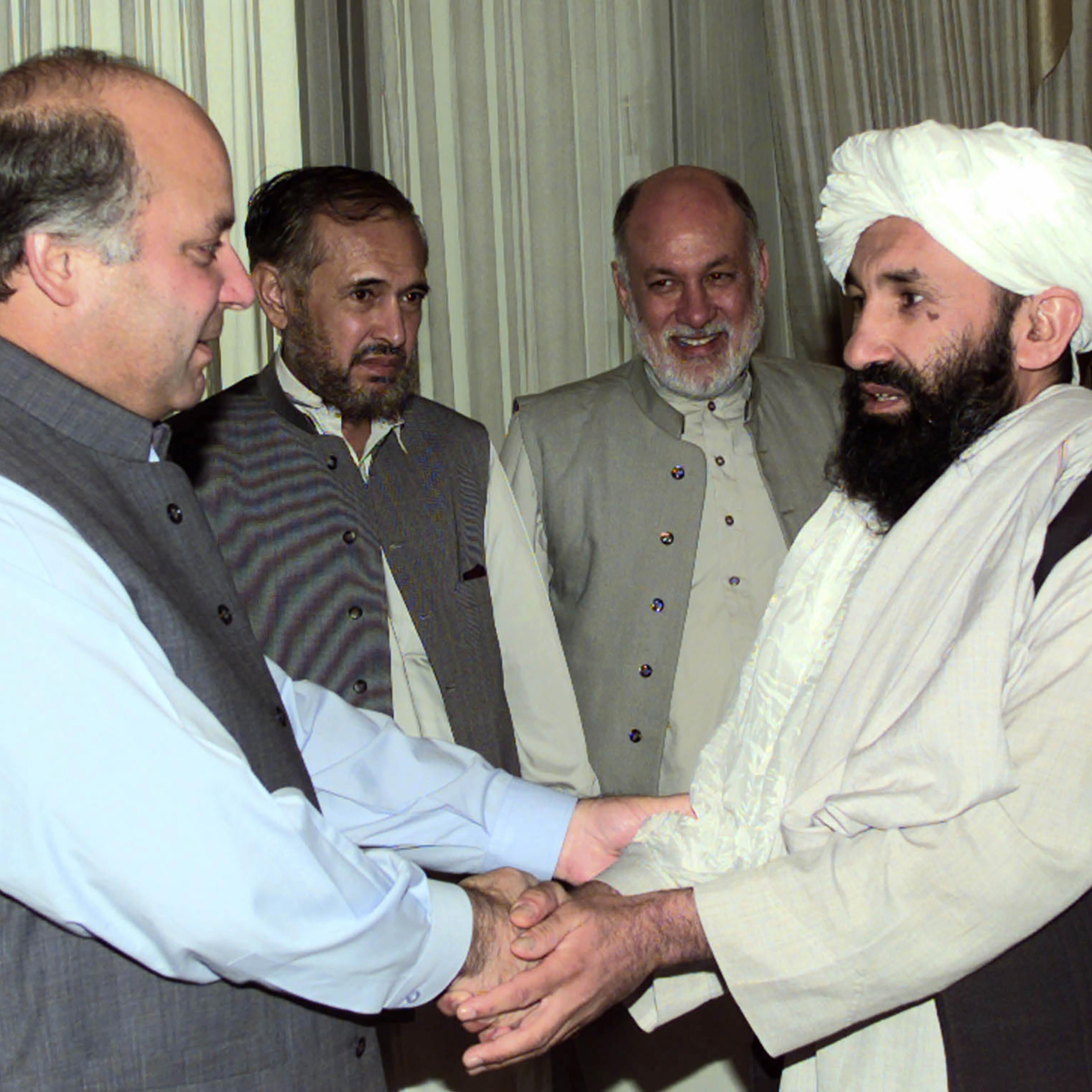 Afghan Foreign Minister Mullah Mohammad Hassan Akhund, right, is greeted by Pakistani Prime Minister Nawaz Sharif in Islamabad, Pakistan, on Aug. 25, 1999.