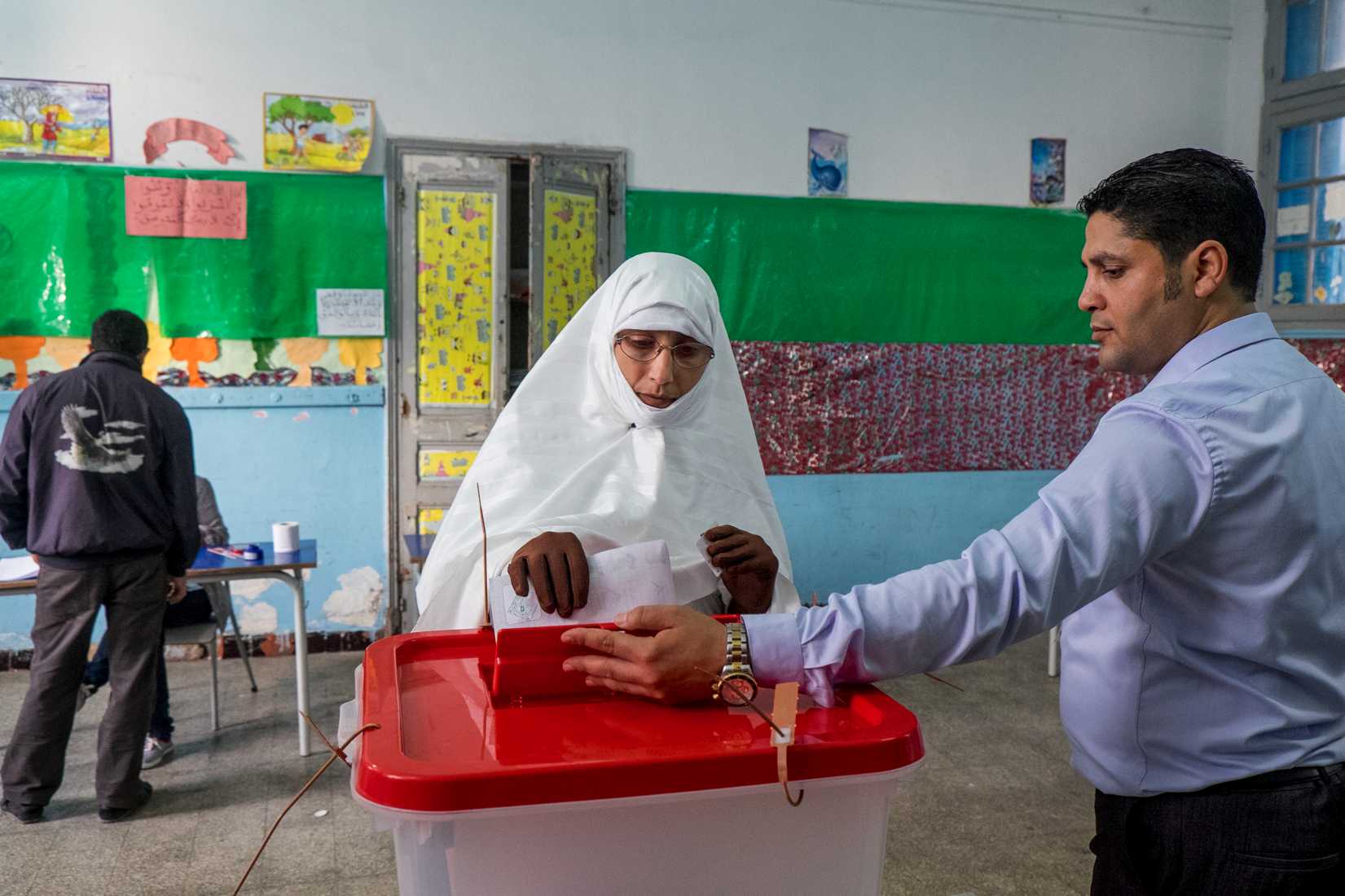 A Tunisian citizen casts her vote at a polling station during the Tunisian presidential election on Nov. 23, 2014, in Fouchana, suburb of Tunis 