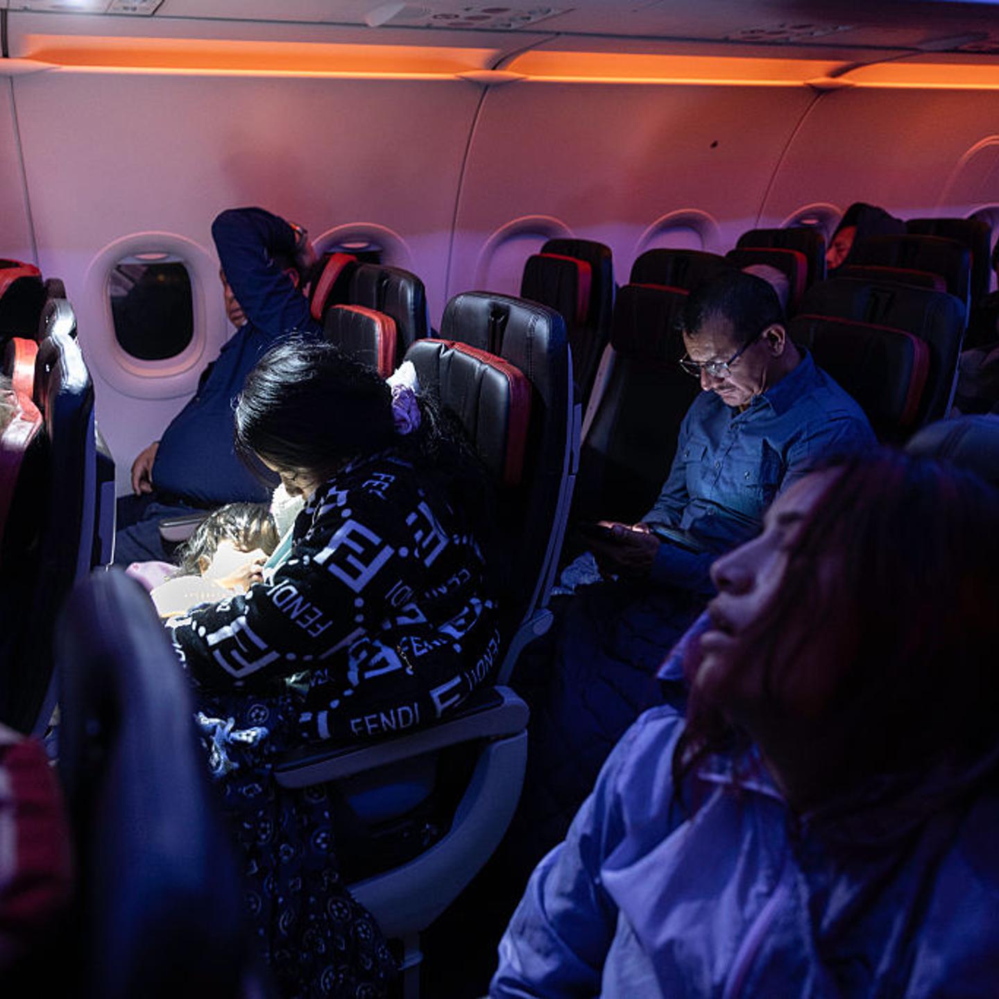 Undocumented mother Andrea, 28, (L) and her cousin Jennyfer, 22, (R) sleep on their overnight flight to Ecuador from JFK International Airport on Oct. 27, 2025.
