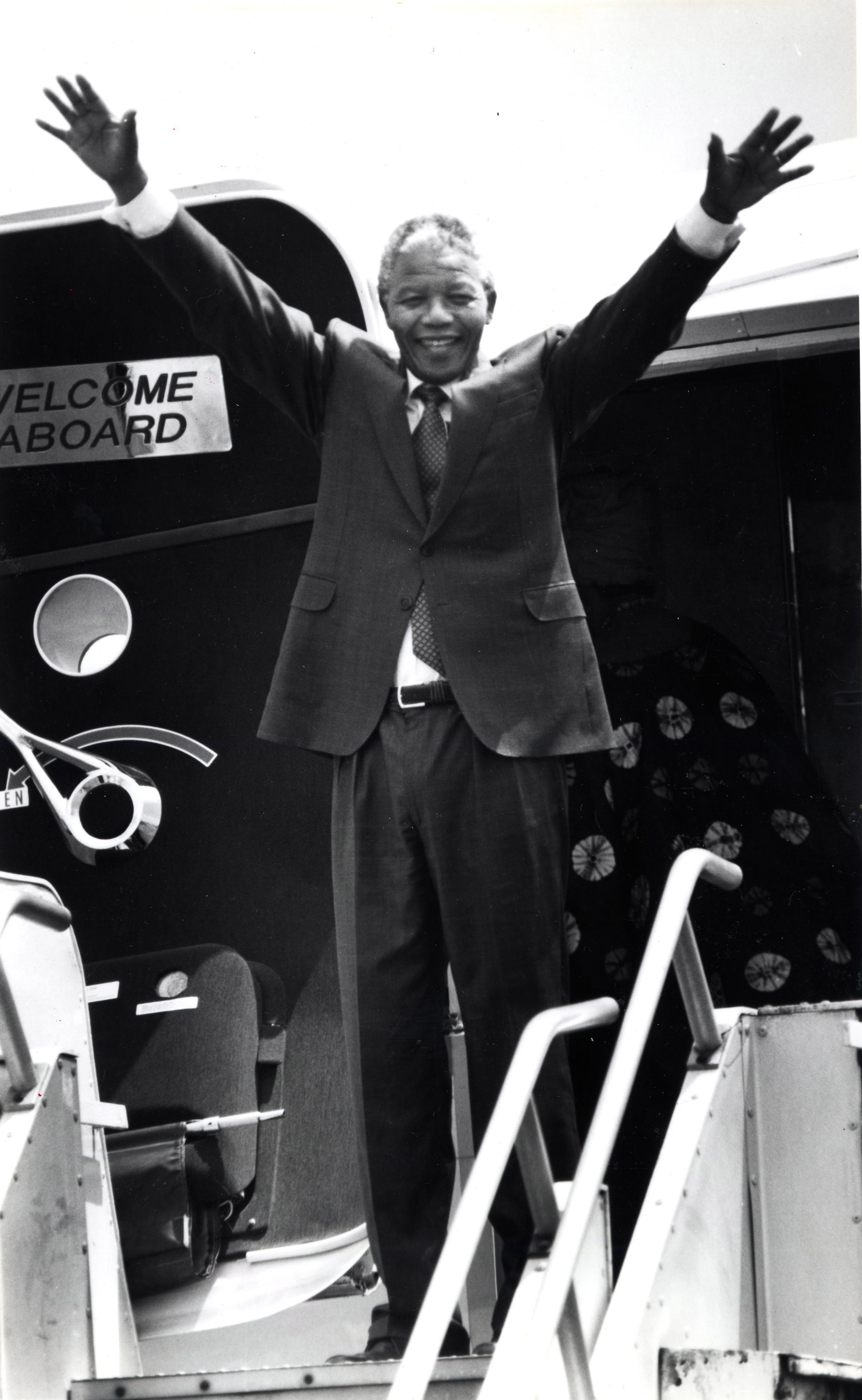 Nelson Mandela waves goodbye to Boston from the airplane doorway on June, 24, 1990.