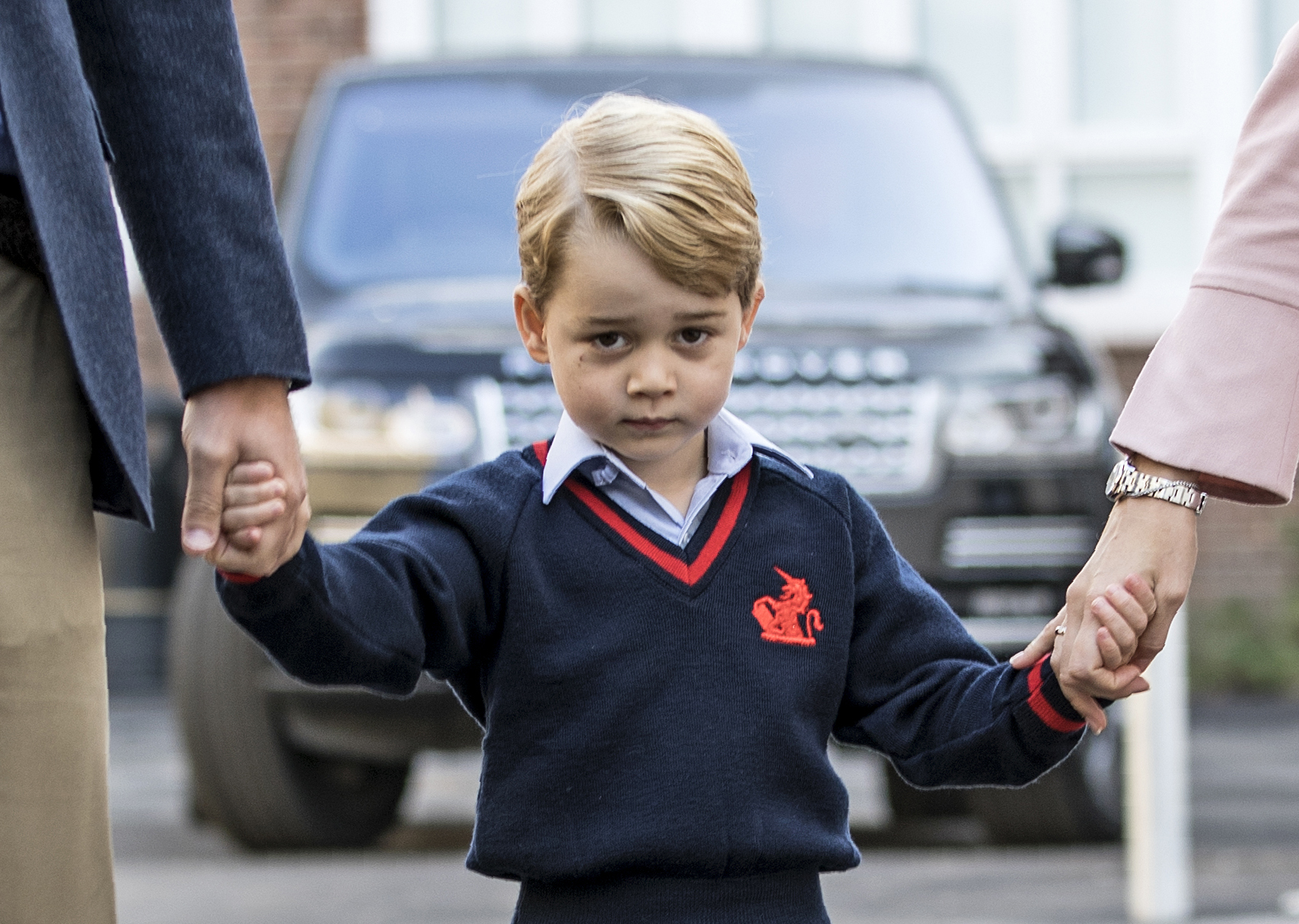 Prince George walking with Prince William