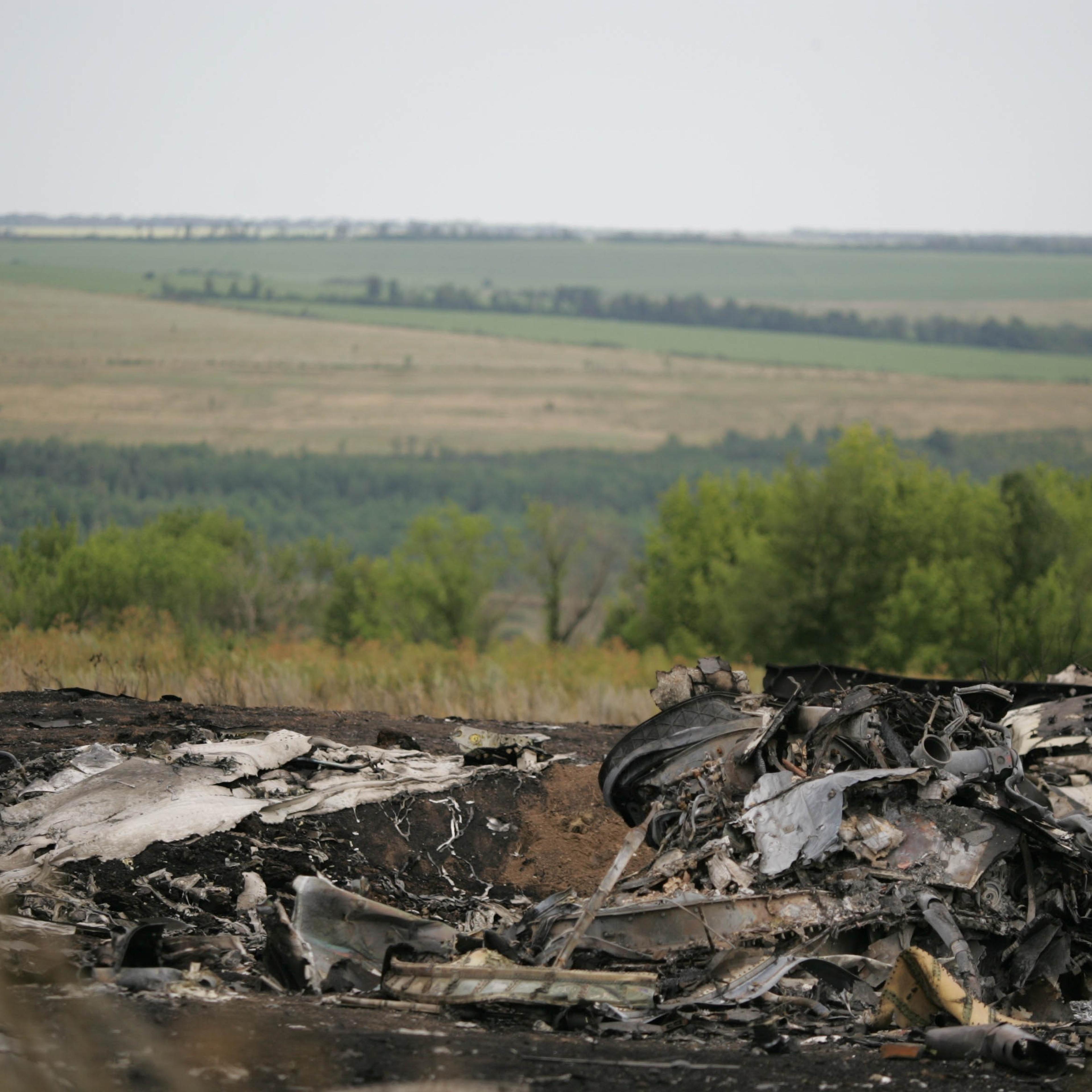 Experts inspect the wreckage of Malaysia Airlines plane