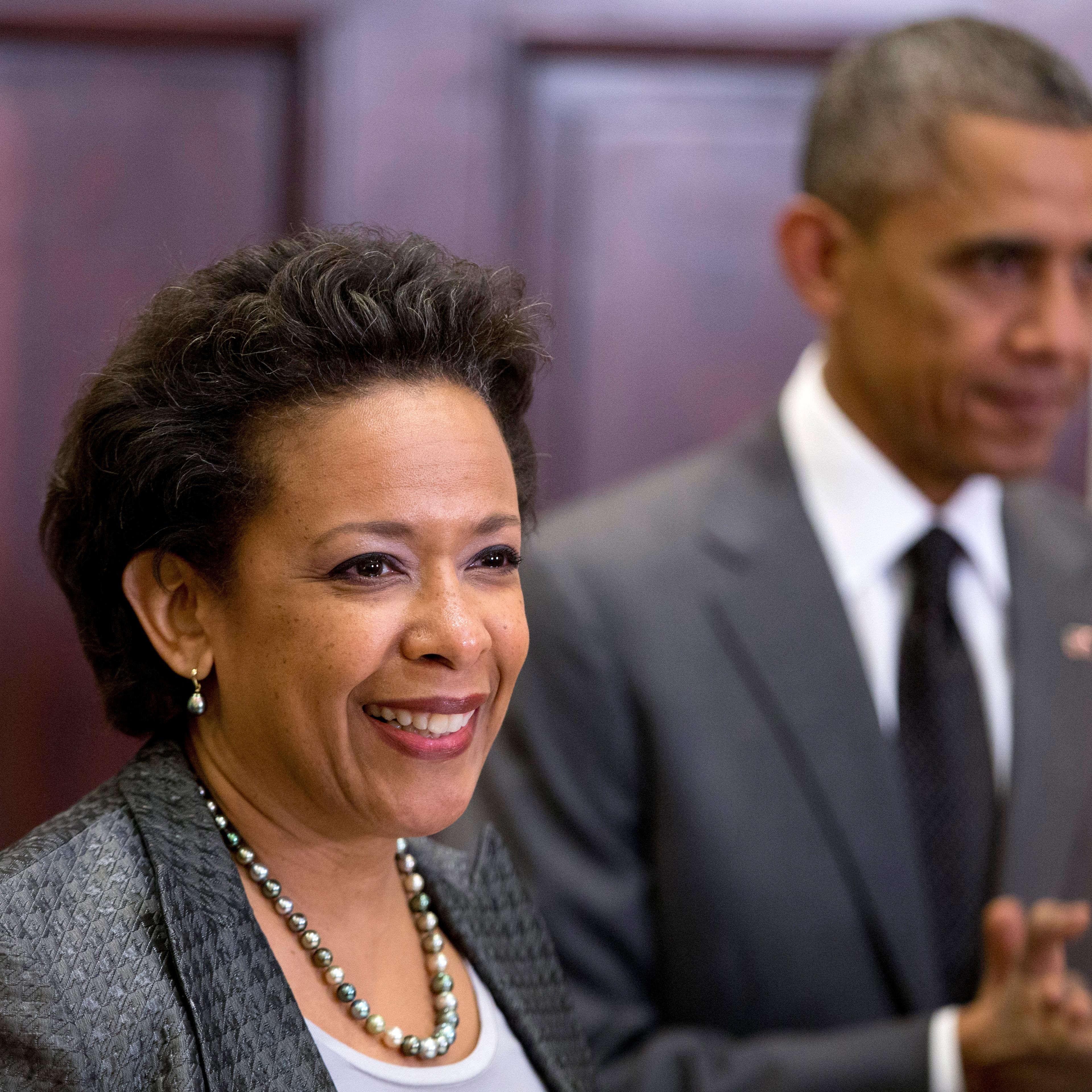 President Barack Obama listens at right as US Attorney Loretta Lynch speaks in the Roosevelt Room of the White House in Washington on Nov. 8, 2014.
