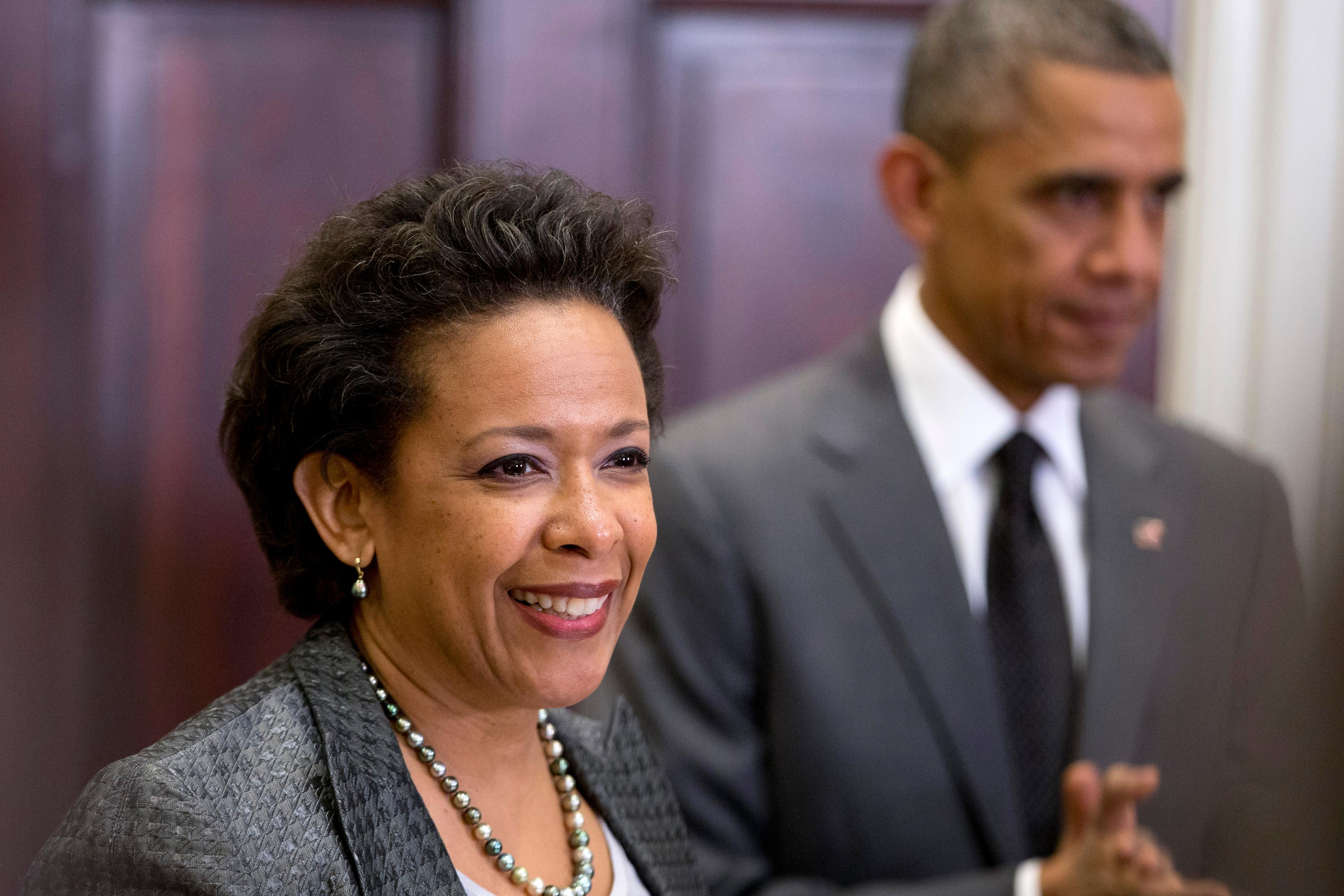 President Barack Obama listens at right as US Attorney Loretta Lynch speaks in the Roosevelt Room of the White House in Washington on Nov. 8, 2014.