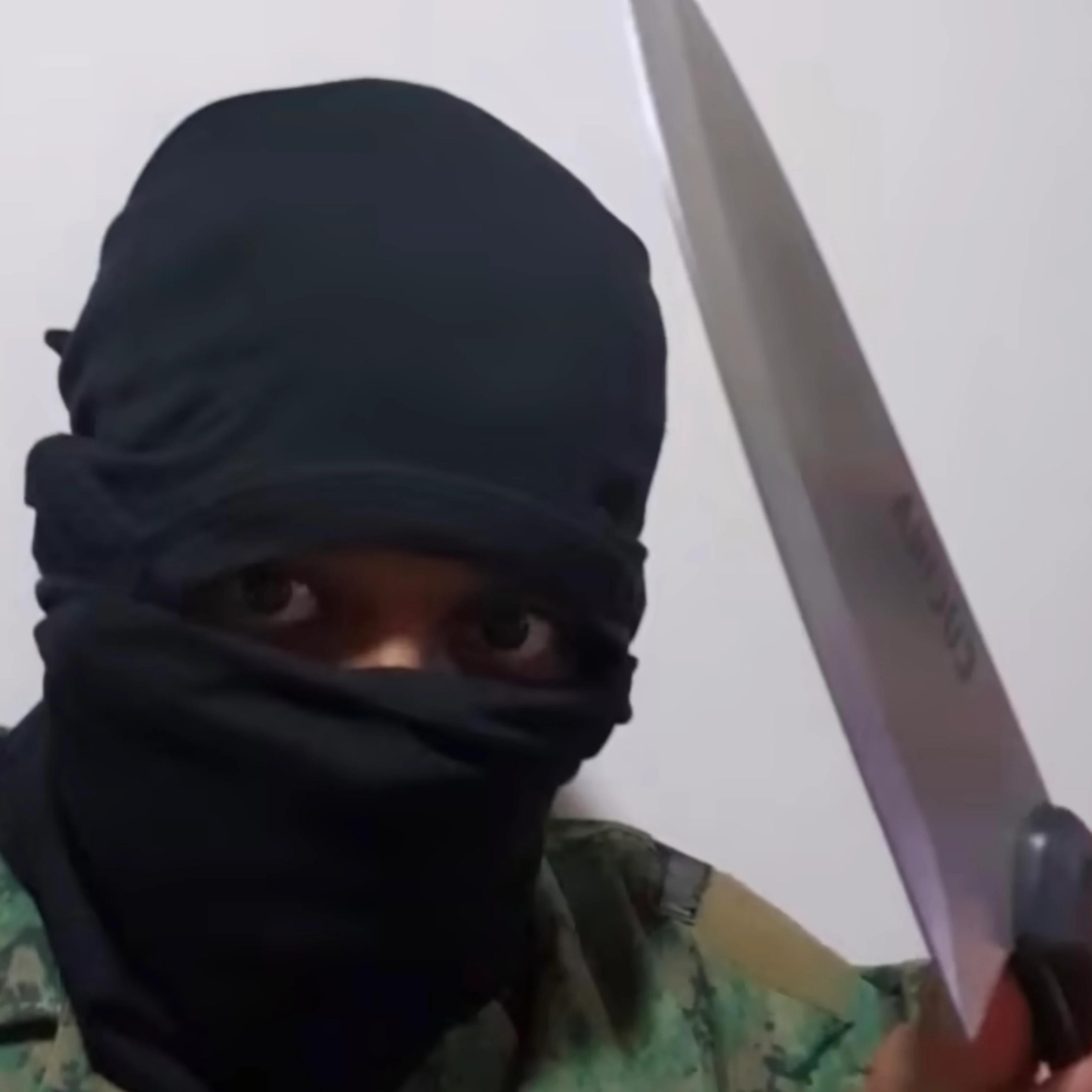 A handout photo released on Feb. 1 of Irfan in a ski mask, posing with a knife.