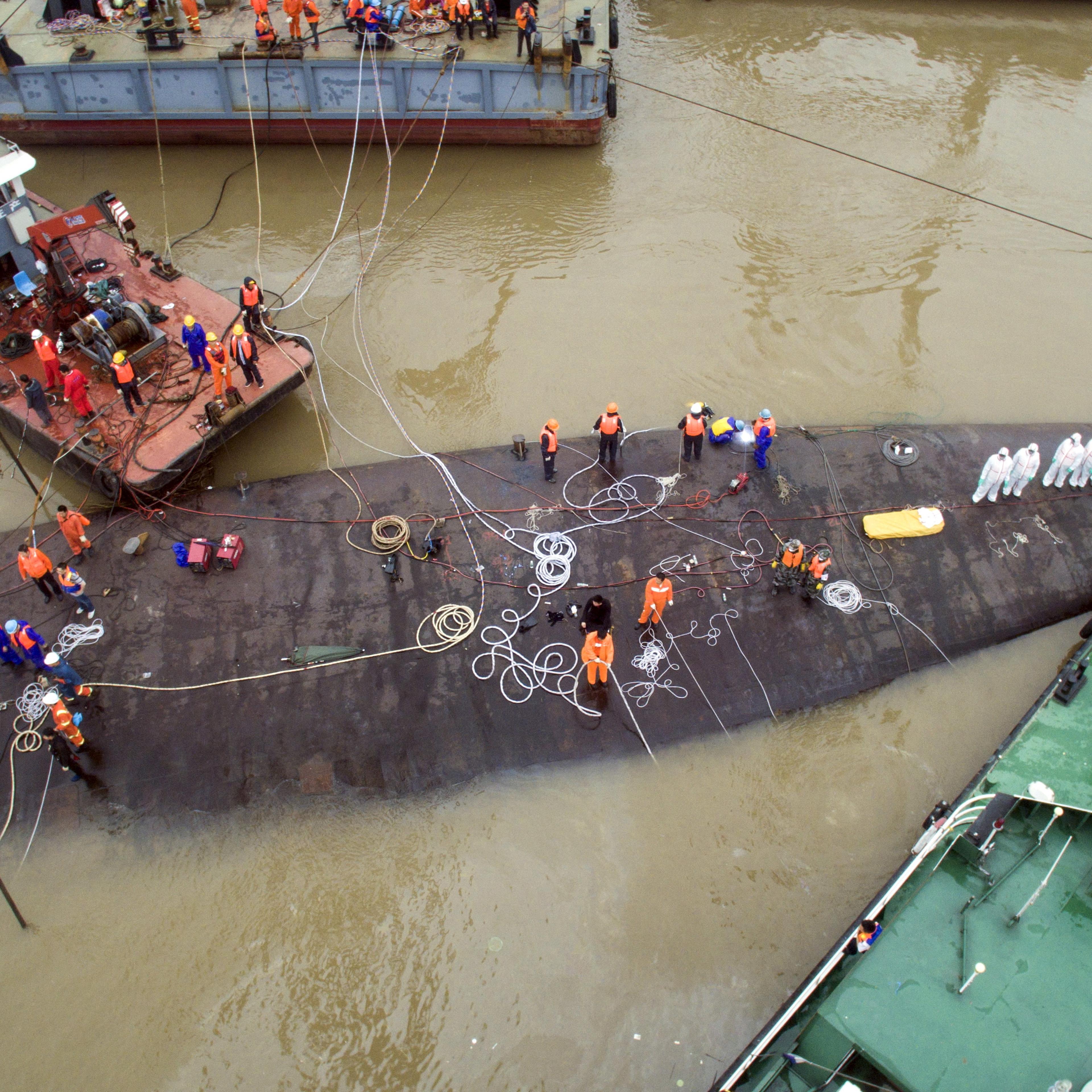 An aerial view shows rescue workers standing on the sunken cruise ship Eastern Star in Jianli