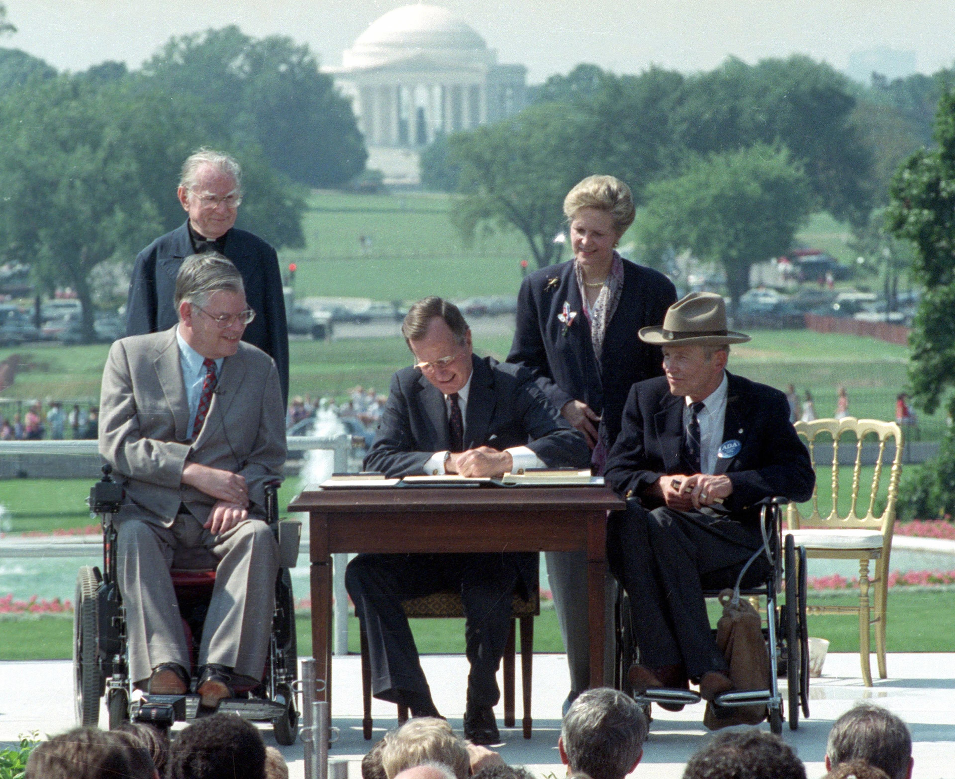 President George H.W. Bush signs the ADA in 1990