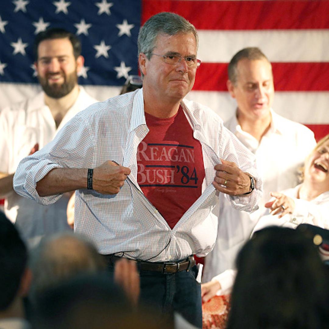 Republican presidential candidate and former Florida Governor Jeb Bush shows off a Reagan/Bush '84 tee-shirt as he speaks during a Miami field office opening on September 12, 2015 in Miami, Florida.