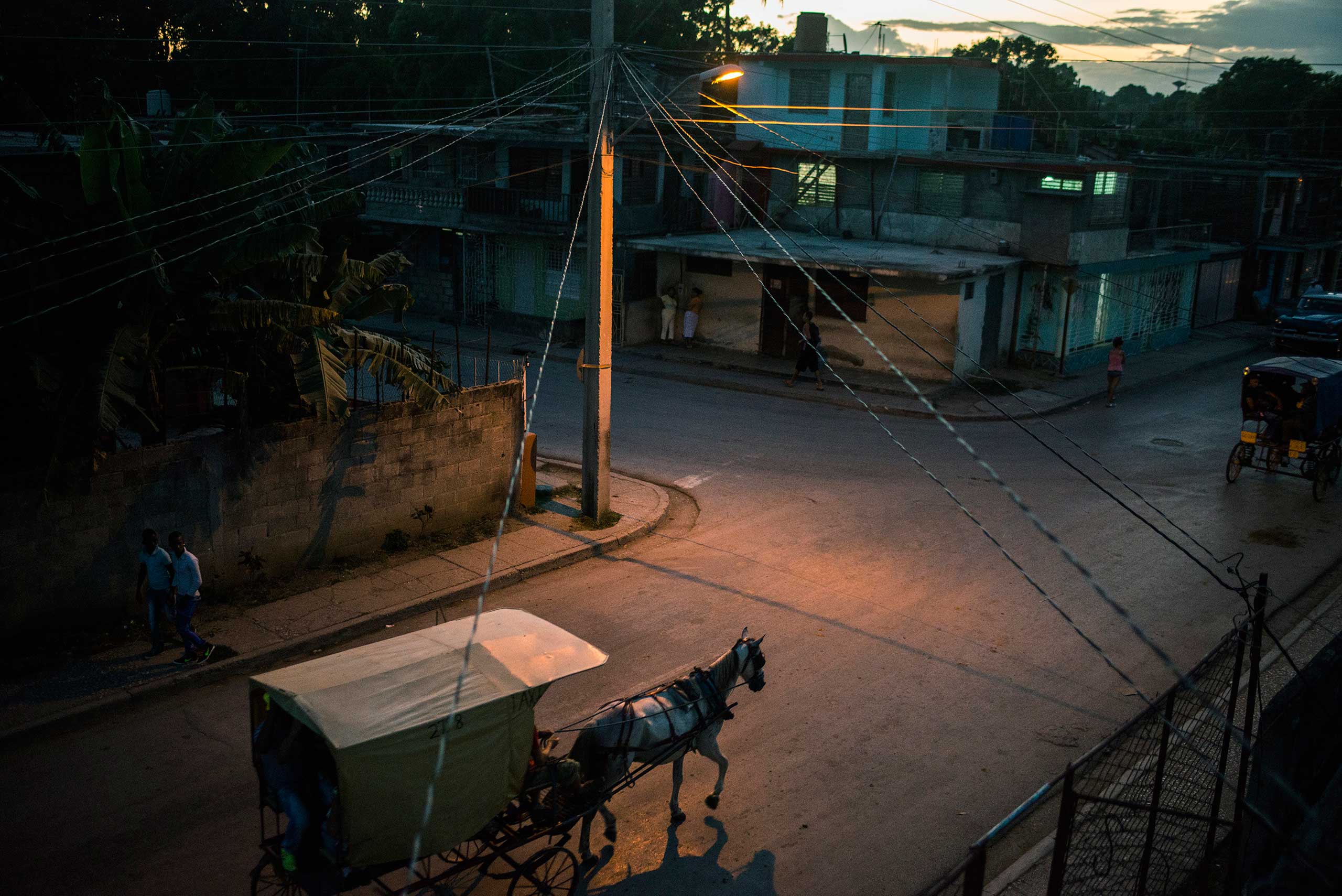 A horse-drawn carriage -- the main form of transportation locally -- navigates the streets of Guantanamo, Cuba, near the island's eastern end.