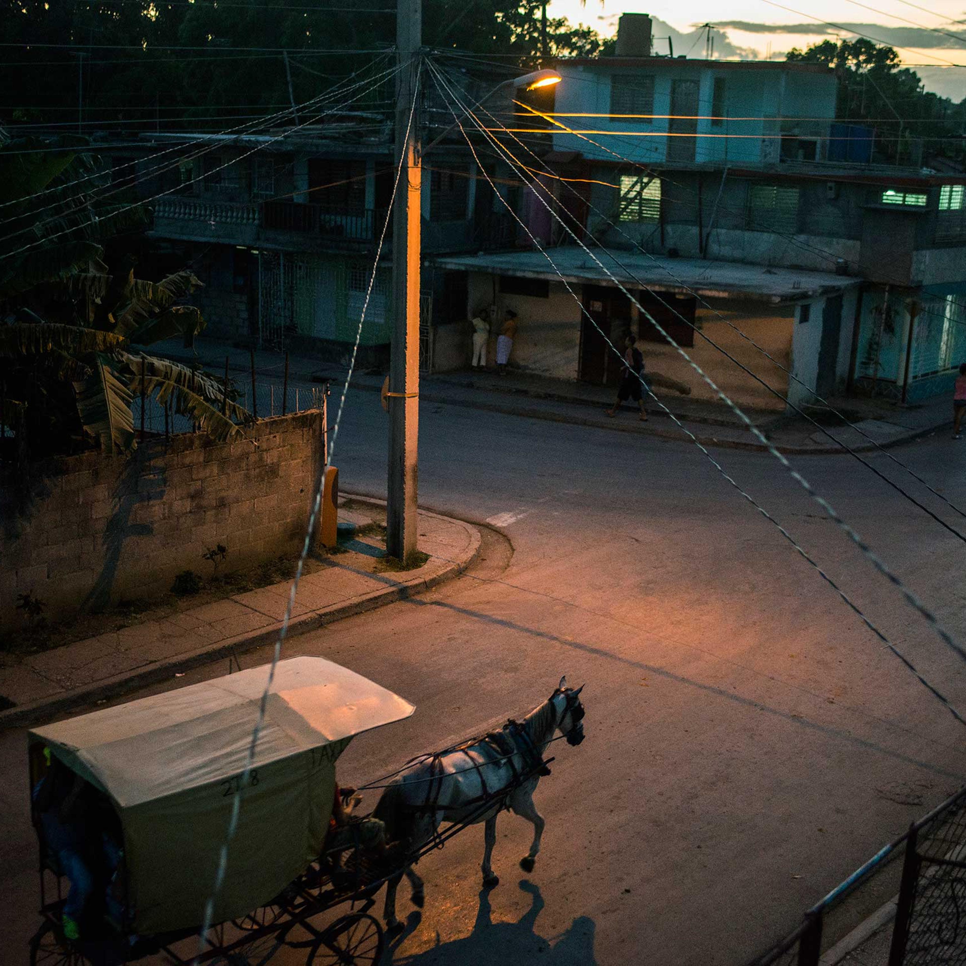 A horse-drawn carriage -- the main form of transportation locally -- navigates the streets of Guantanamo, Cuba, near the island's eastern end.