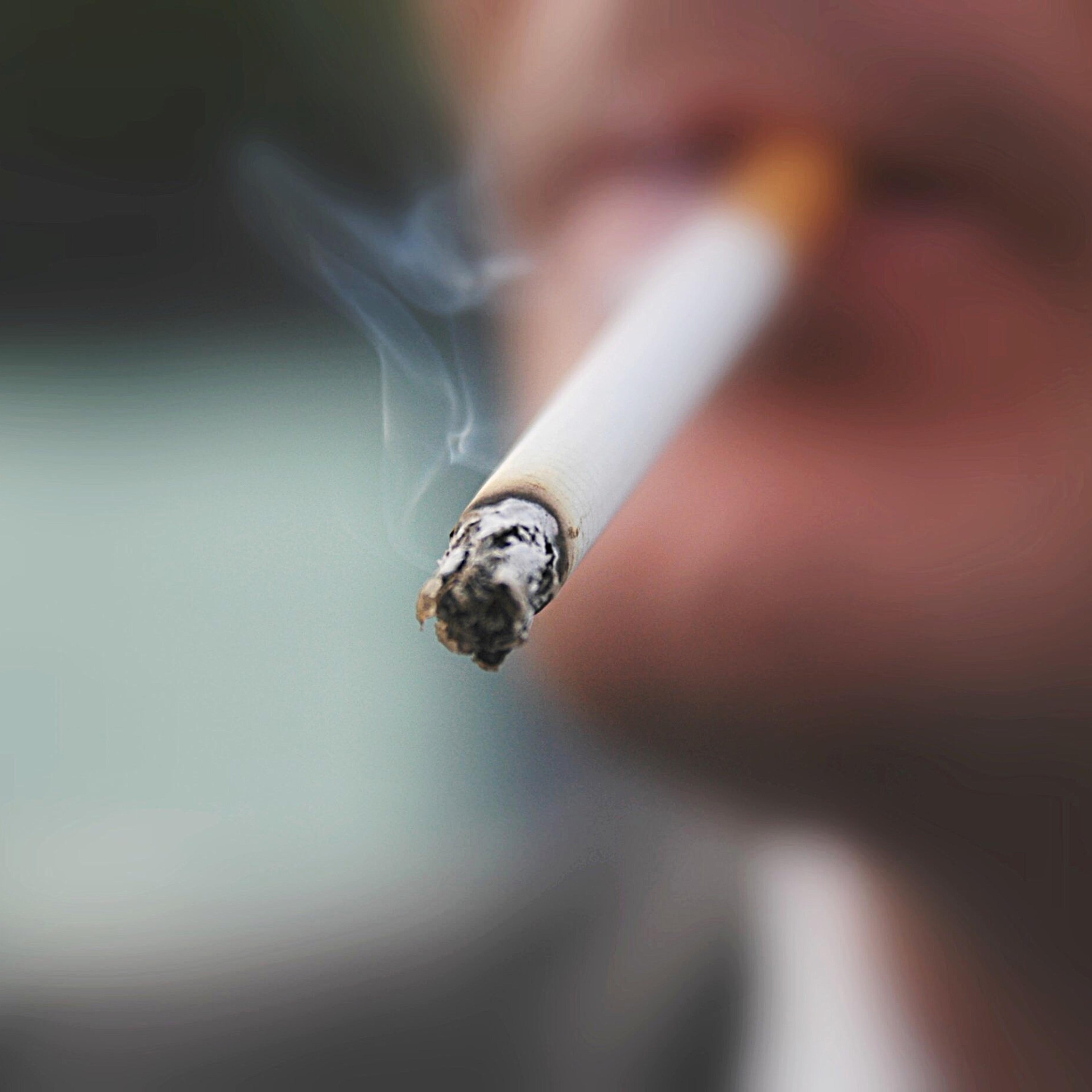 Midsection Of Man Smoking Cigarette