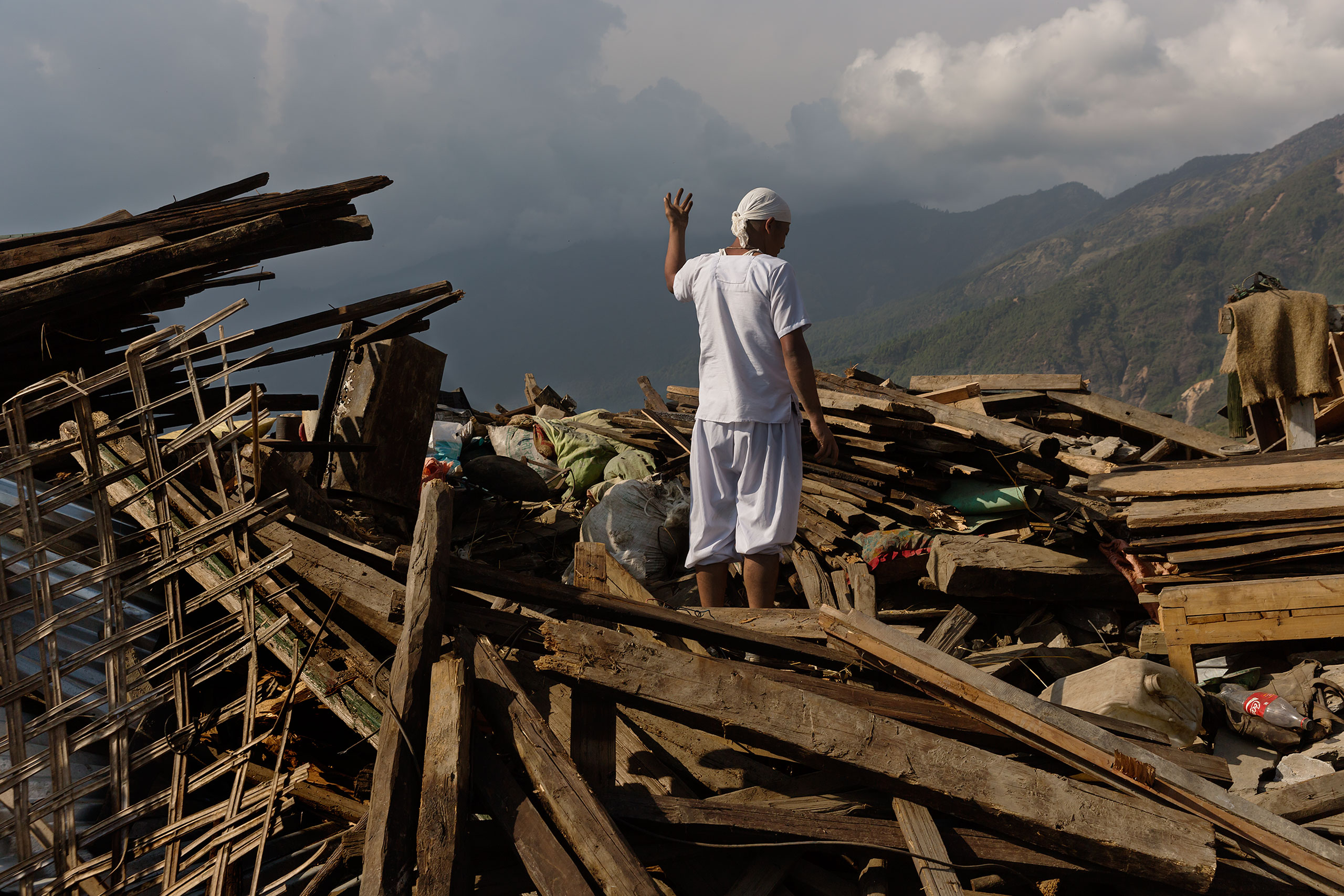 Nepal earthquake. Barpak, the epicenter of the earthquake. Funeral of Pur Bahadur Gurung, 26, who had just been dug out of the rubble. Saainli Gurung, his mother weeping. Scenes of villagers salvaging building materials and personal possessions. Dhan Raj