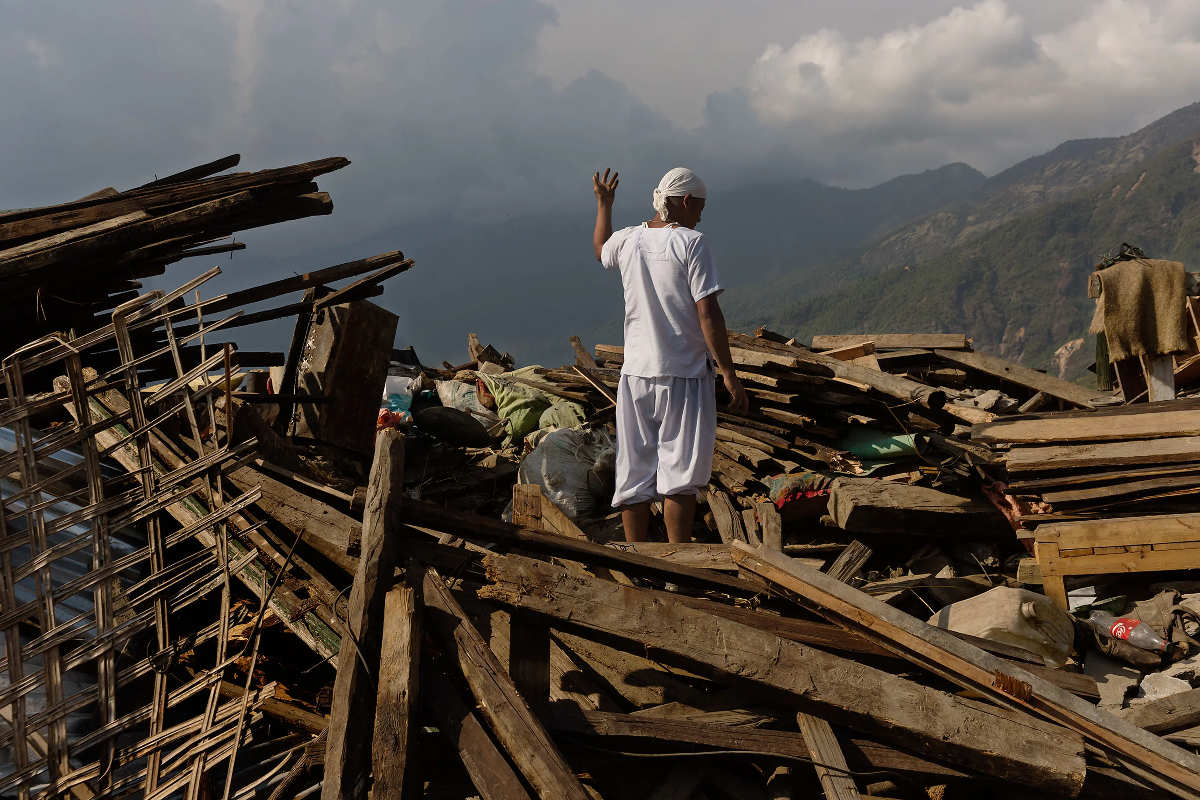 Nepal earthquake. Barpak, the epicenter of the earthquake. Funeral of Pur Bahadur Gurung, 26, who had just been dug out of the rubble. Saainli Gurung, his mother weeping. Scenes of villagers salvaging building materials and personal possessions. Dhan Raj