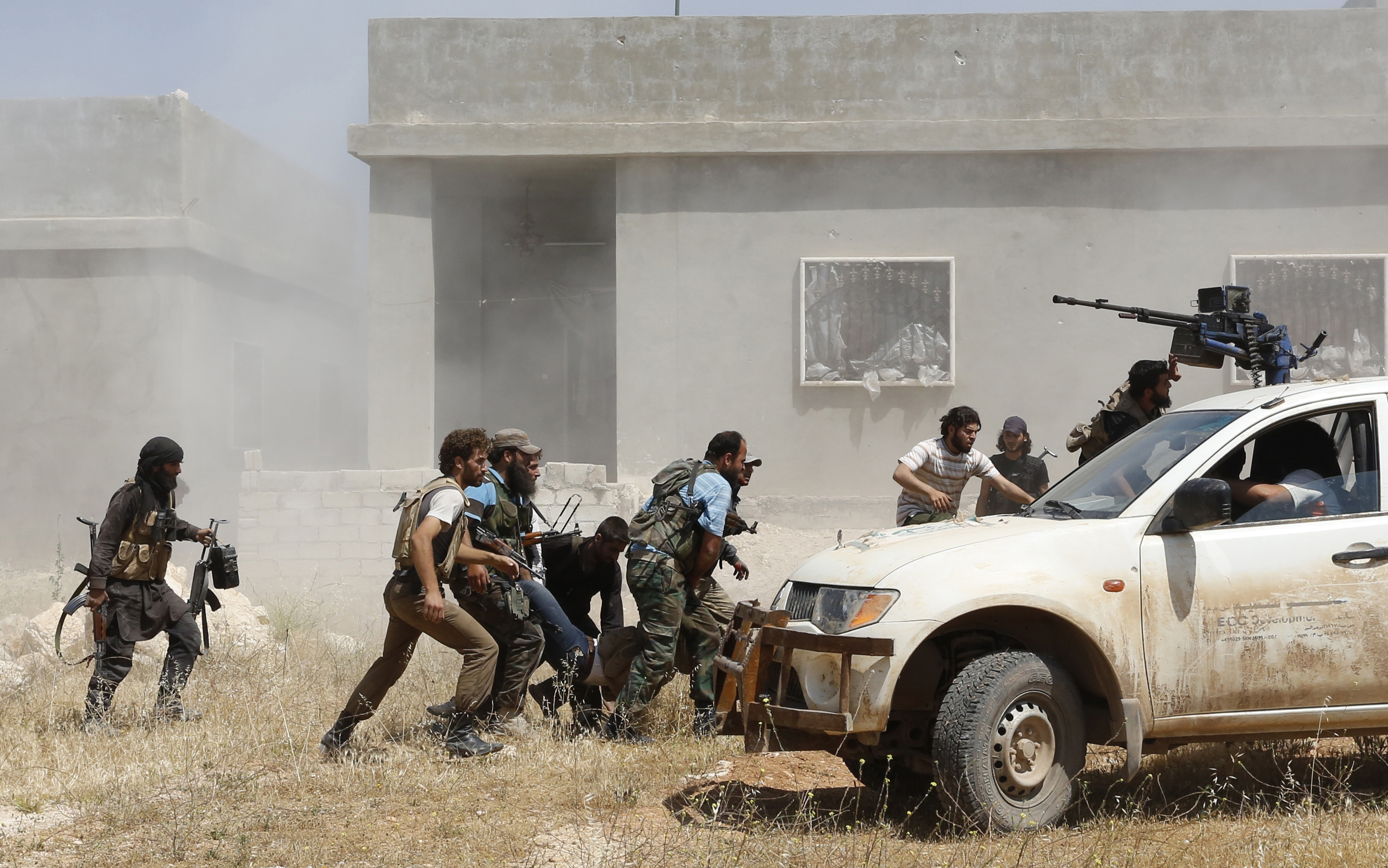 Free Syrian Army fighters help a fellow fighter wounded after what they said was clashes with forces loyal to Syria's President Bashar al-Assad, in Morek in Hama province