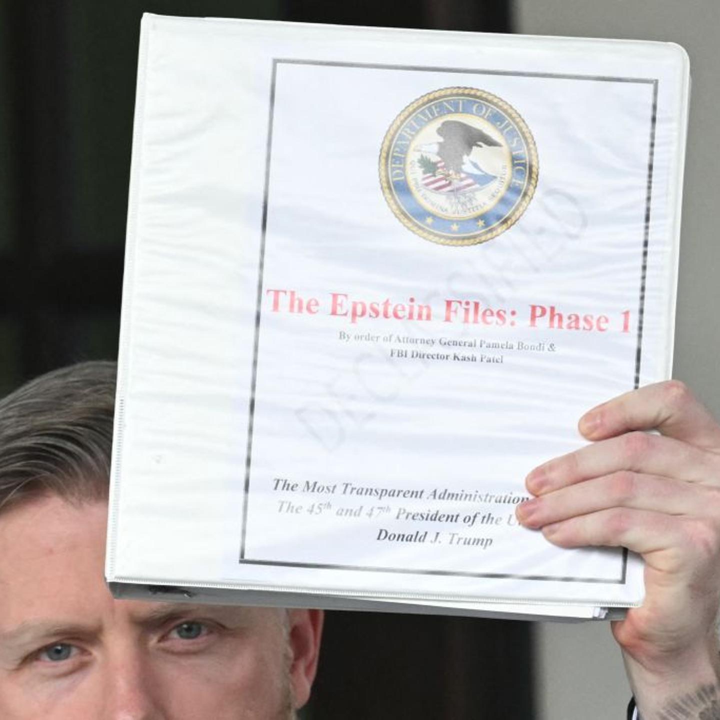 Political commentator Rogan O'Handley, aka "DC Draino," and other unidentified people carrying binders bearing the seal of the U.S. Justice Department reading "The Epstein Files: Phase 1" walk out of the West Wing of the White House in Washington, D.C.,