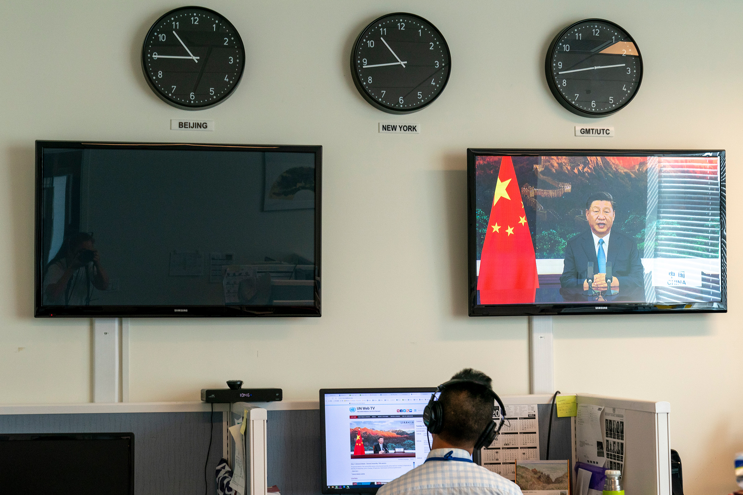 A Xinhua reporter watches as Xi remotely addresses the U.N. General Assembly on Sept. 22