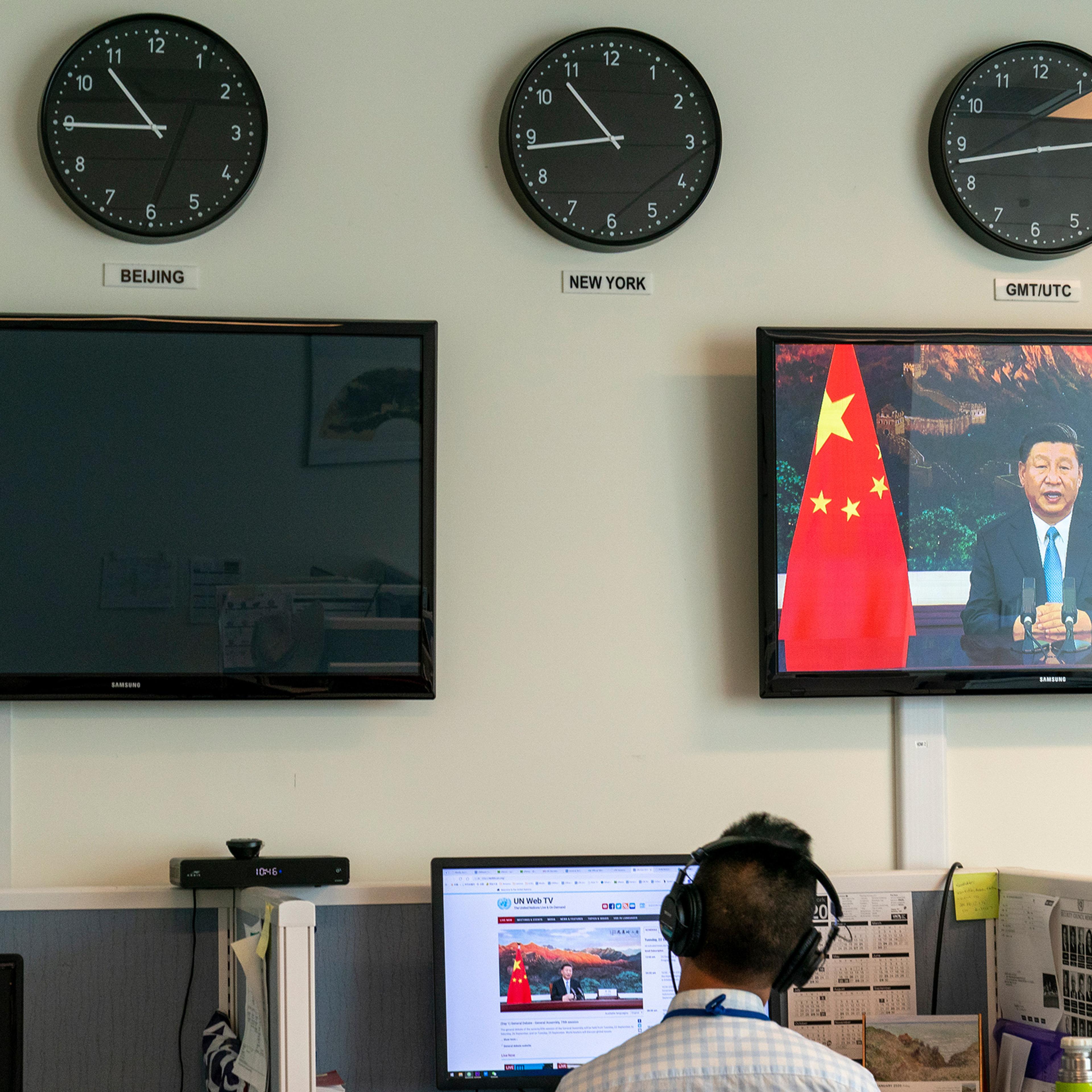 A Xinhua reporter watches as Xi remotely addresses the U.N. General Assembly on Sept. 22