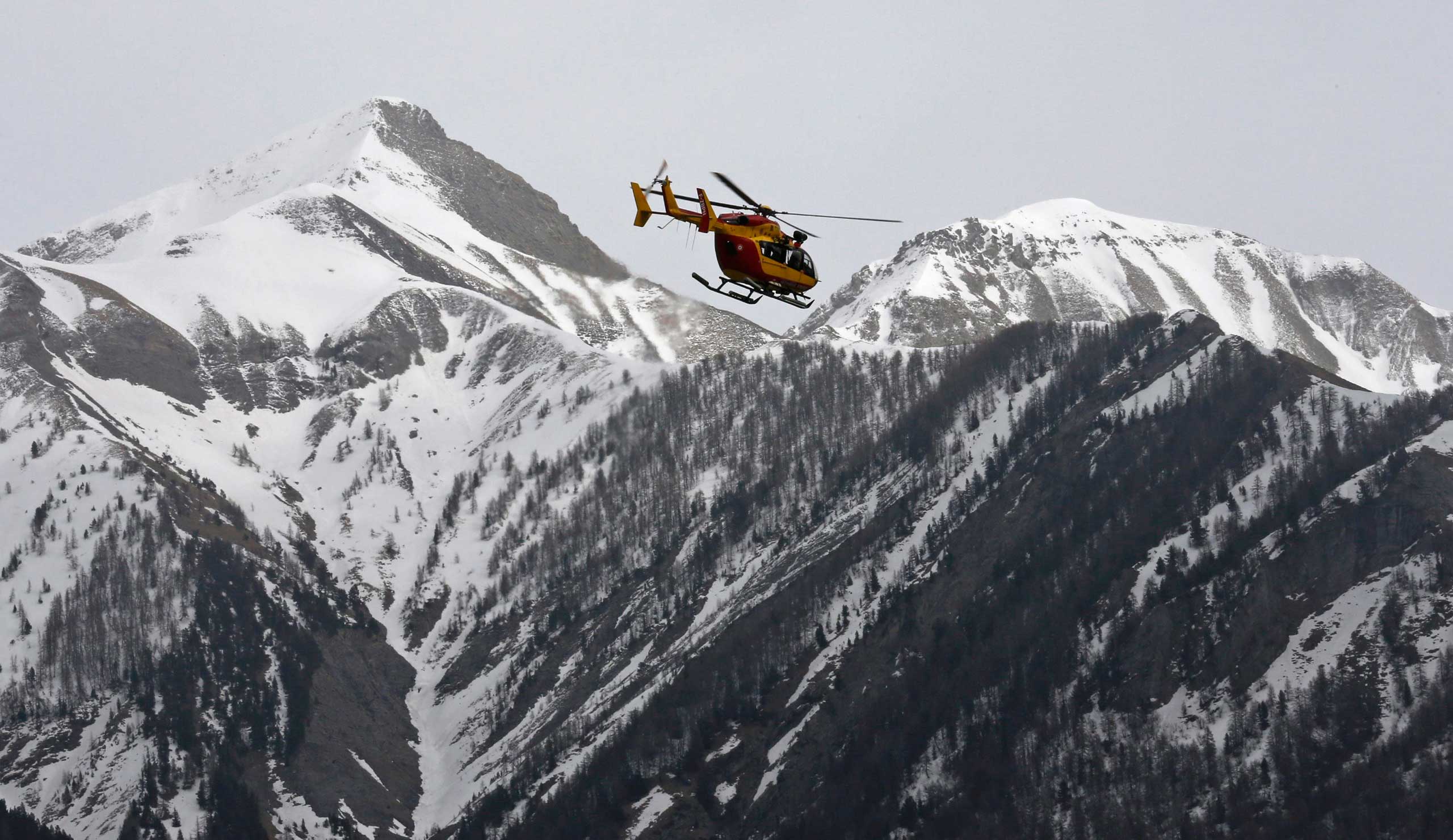 A rescue helicopter from the French Securite Civile flies over the French Alps during a rescue operation after the crash of an Airbus A320, near Seyne-les-Alpes, March 24, 2015.