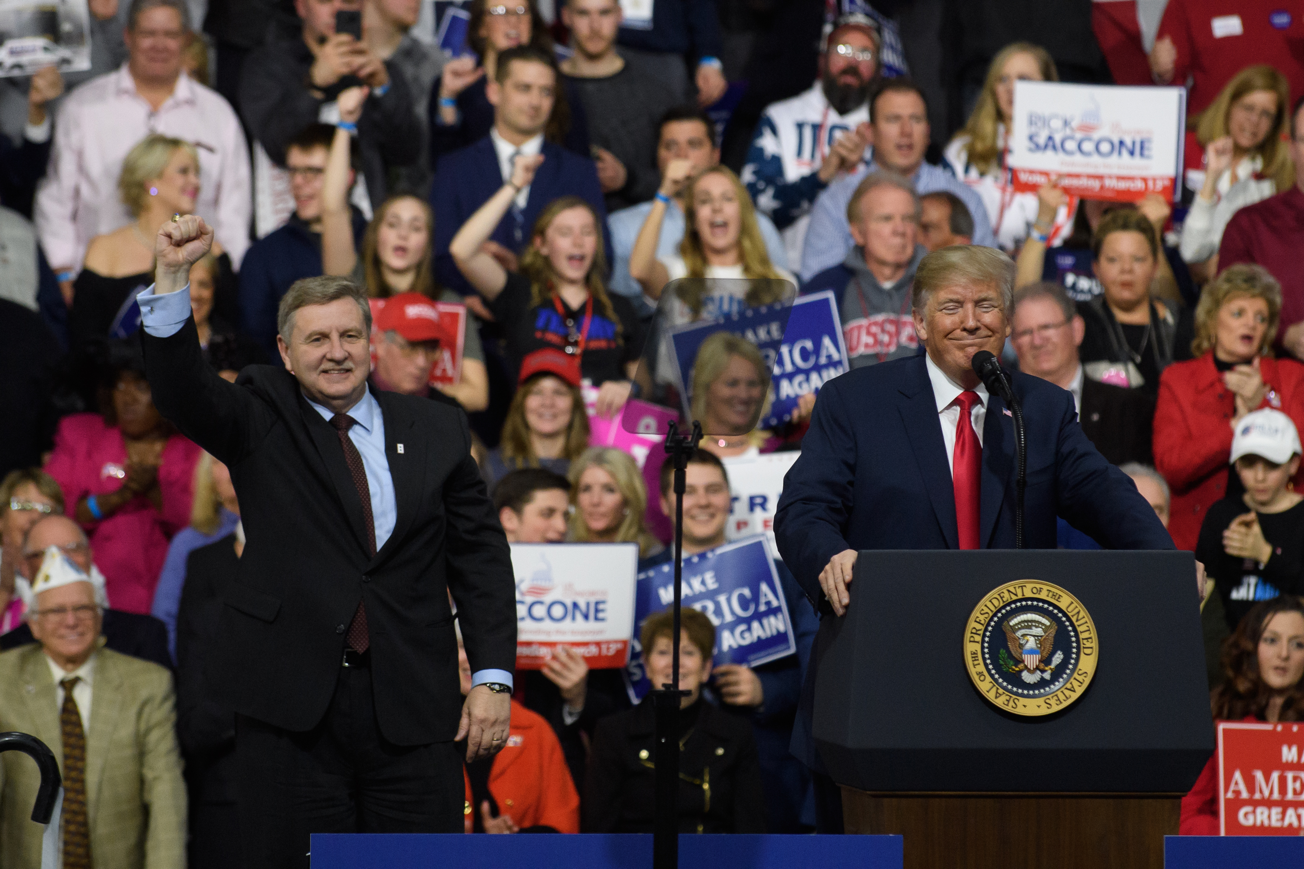 President Donald J. Trump with Rick Saccone speaks to supporters at the Atlantic Aviation Hanger on March 10, 2018 in Moon Township, Pennsylvania.