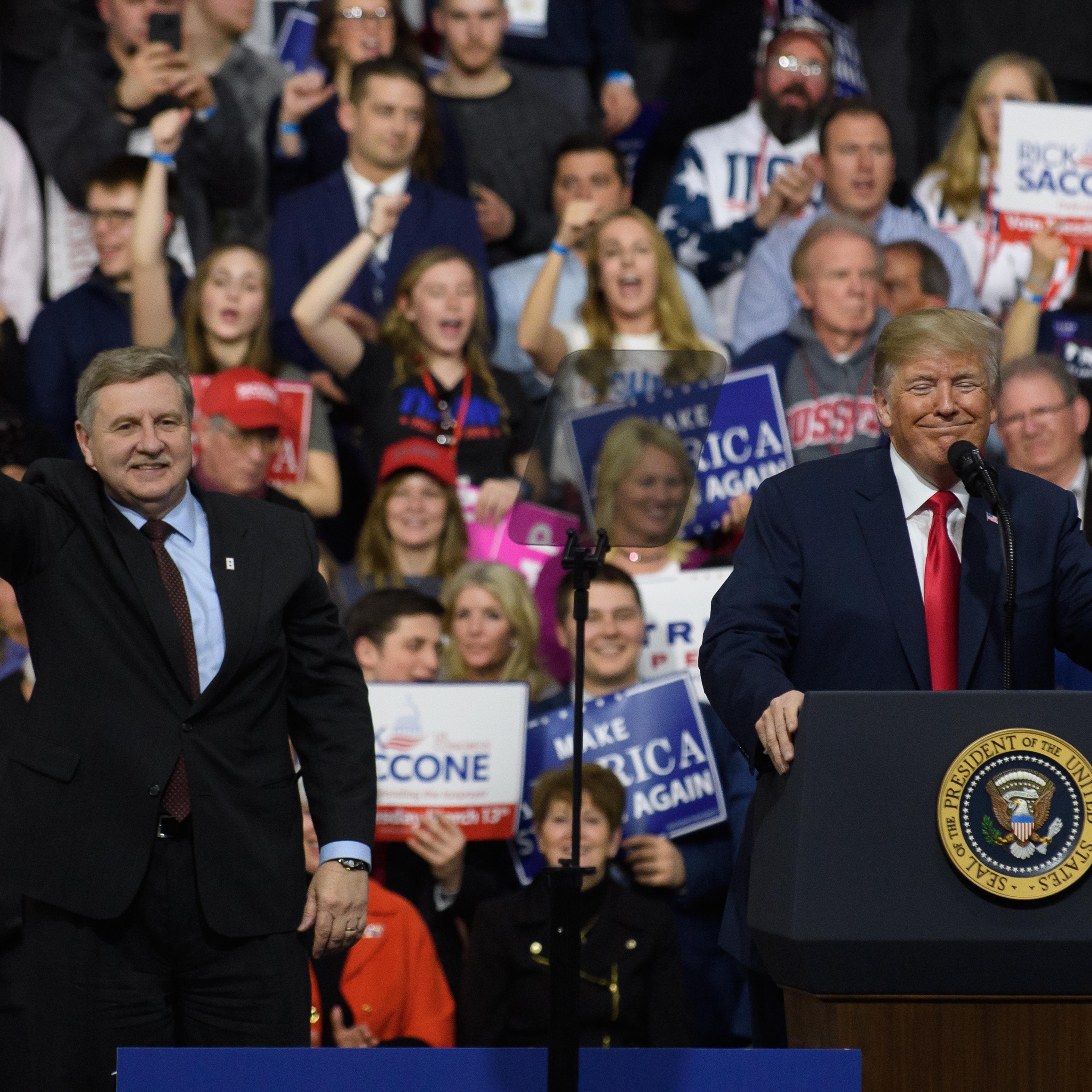 President Donald J. Trump with Rick Saccone speaks to supporters at the Atlantic Aviation Hanger on March 10, 2018 in Moon Township, Pennsylvania.