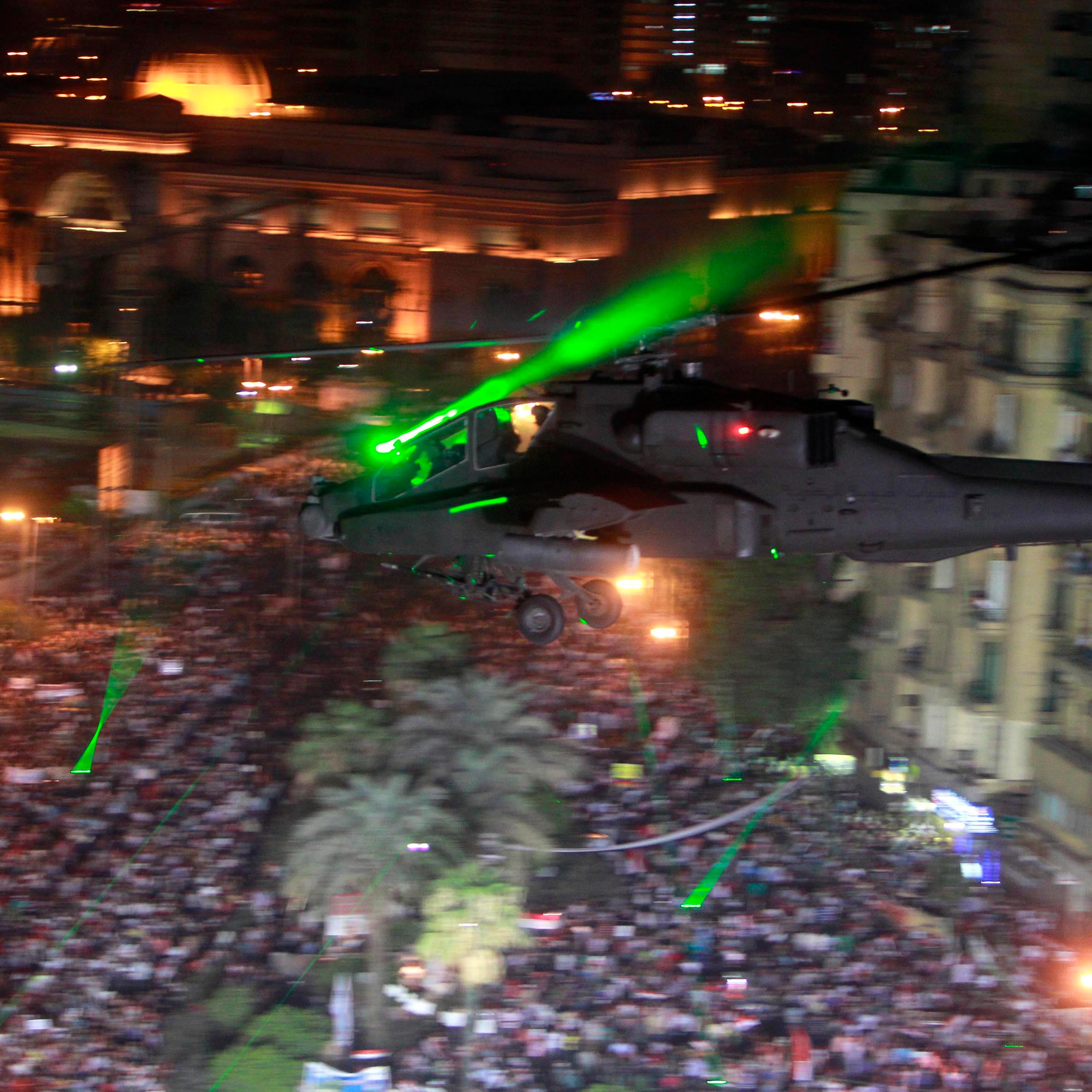 An Apache helicopter flies over Tahrir Square during a protest to support the army in Tahrir square in Cairo