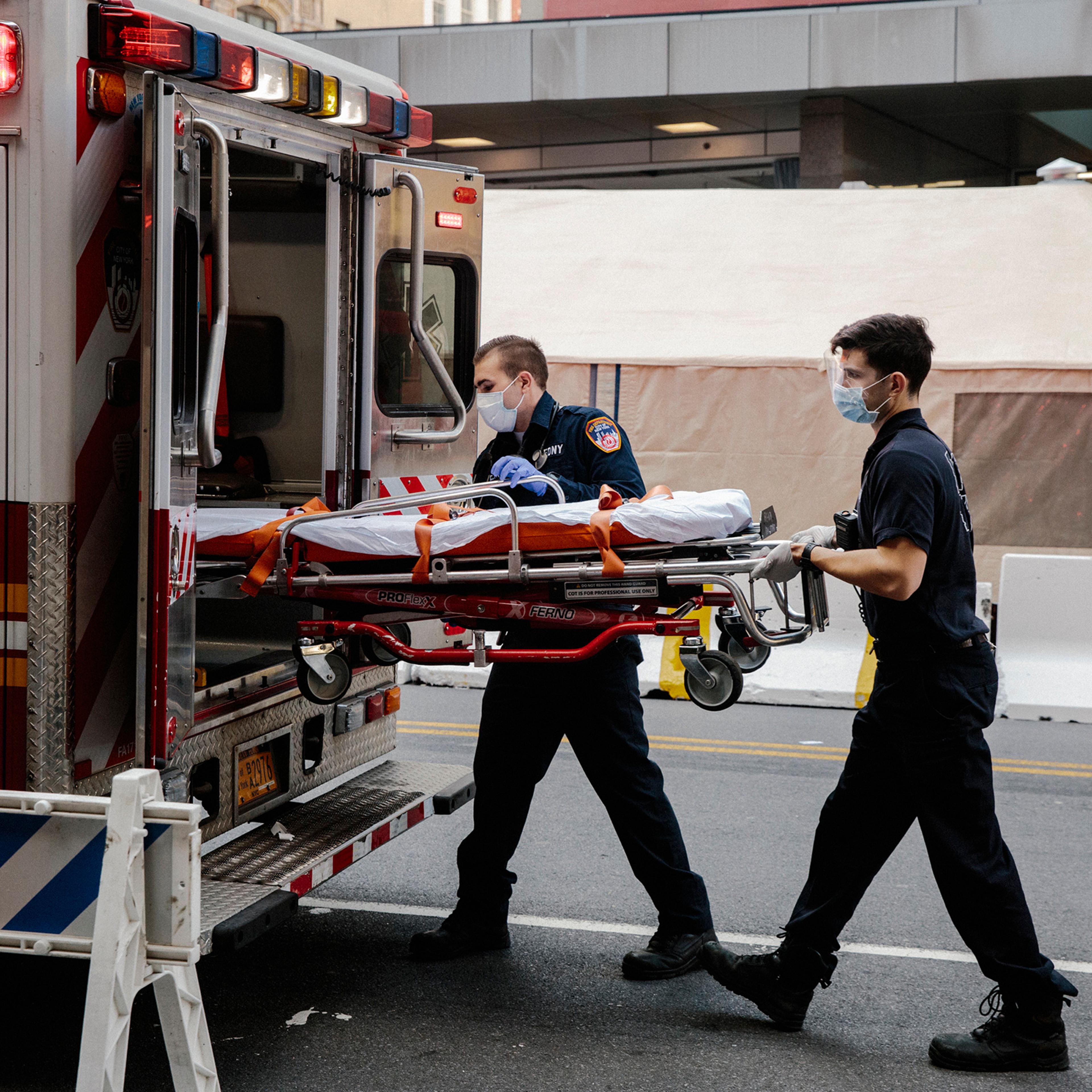 Emergency medical technicians after transporting a possible coronavirus patient outside of New York Presbyterian Lower Manhattan Hospital, Thursday, March 26, 2020. (Mark Abramson/The New York Times)