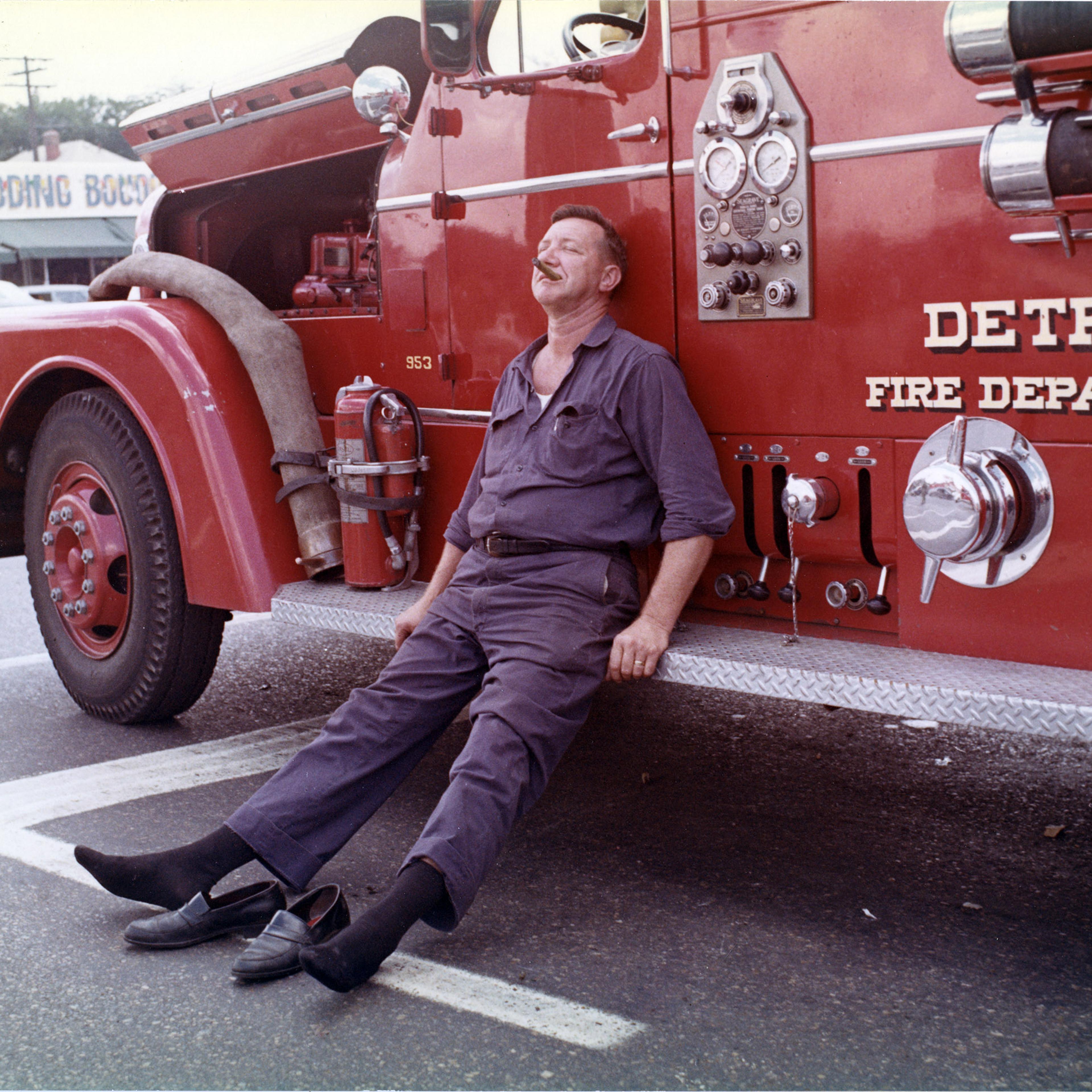 A Detroit firefighter collapses against the side of a department vehicle after battling one of the 1,609 structures that were damaged in the city during the July ’67 protests.